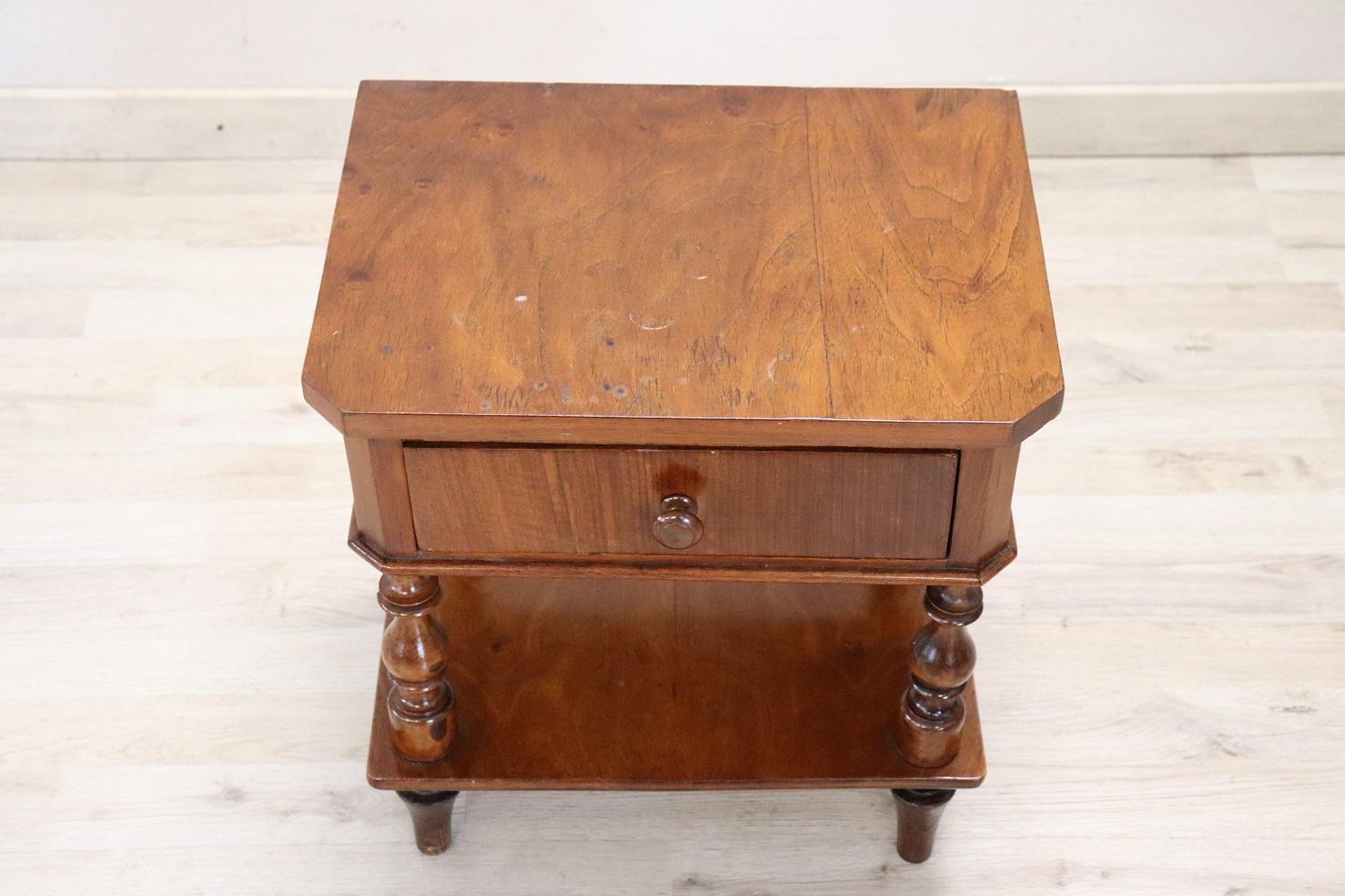 Rare and fine quality Italian Louis Philippe 1850s antique nightstand solid walnut. On the front one comfortable drawer. Characterized by elegant turned legs and a useful shelf in the lower part. Very good condition.