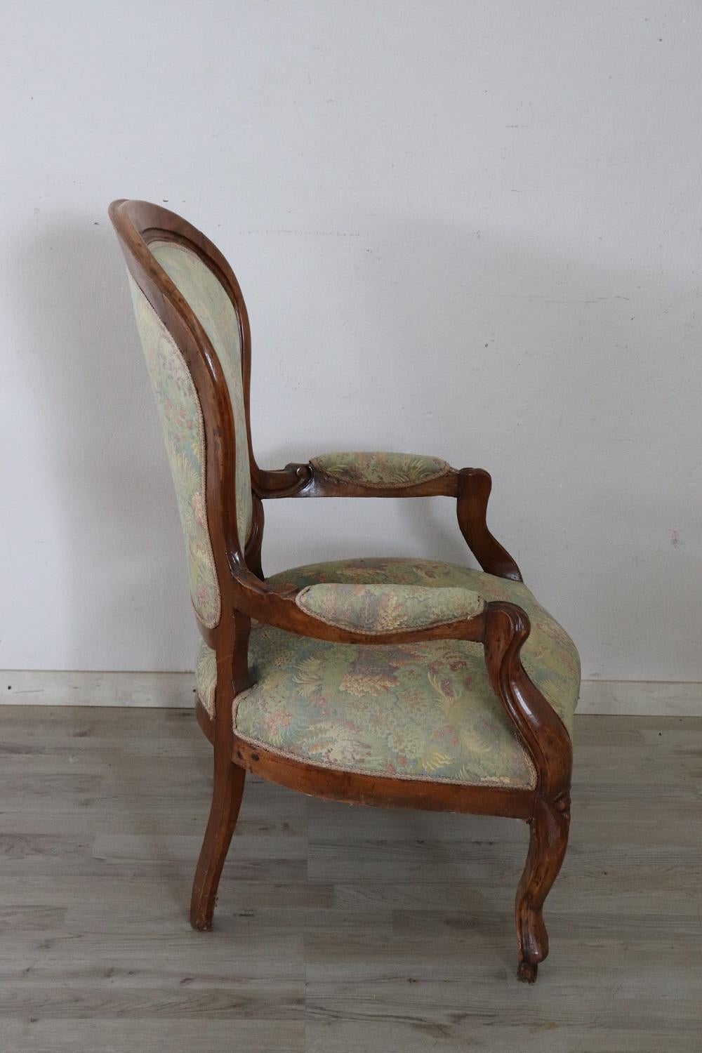 Lovely Italian armchair in solid walnut. This beautiful armchair has an enveloping shape and a comfortable seat. The enveloping and relaxing backrest.
 
