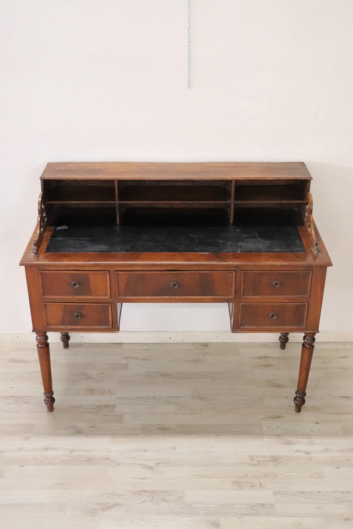 Elegant and essential antique Italian writing desk. Louis Philippe period with Classic shapely legs. Has a long drawer on the front and four small drawers. Above the plane many compartments for your letters or books. Rare and precious veneered