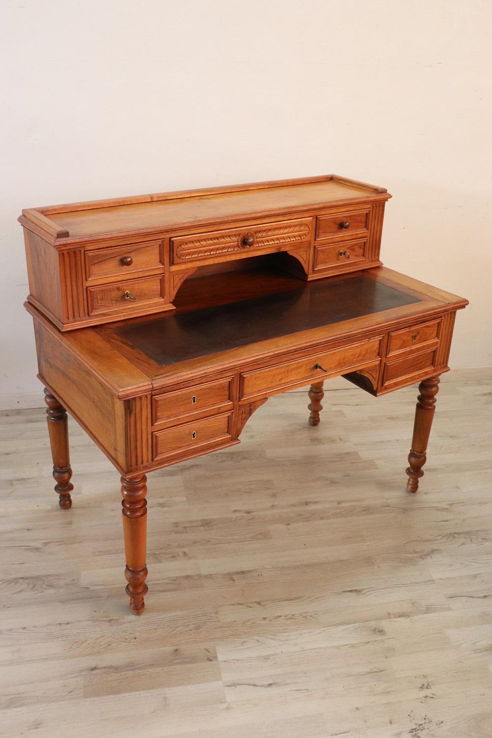 Elegant antique Italian writing desk. Rare and precious solid walnut wood. Comfortable size for a practical use. The desk has elegant turned legs. In the lower part five drawers and in the upper part five smaller drawers. The leather-lined top
