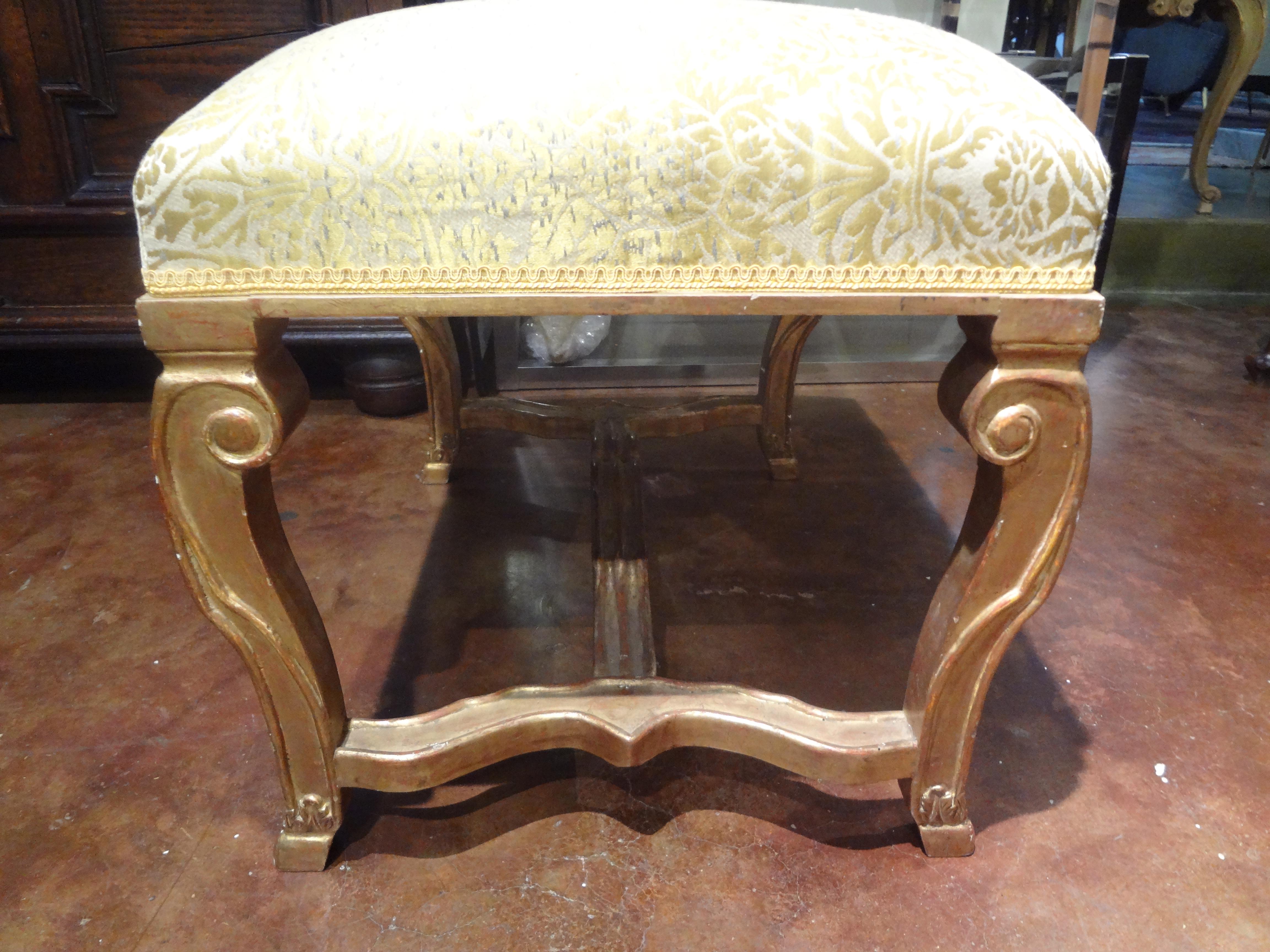 Stunning 19th century Italian Louis XIV style giltwood bench, ottoman or stool. This antique Italian giltwood bench is in very good structural condition and currently upholstered in silk which could be easily upholstered in the fabric of your