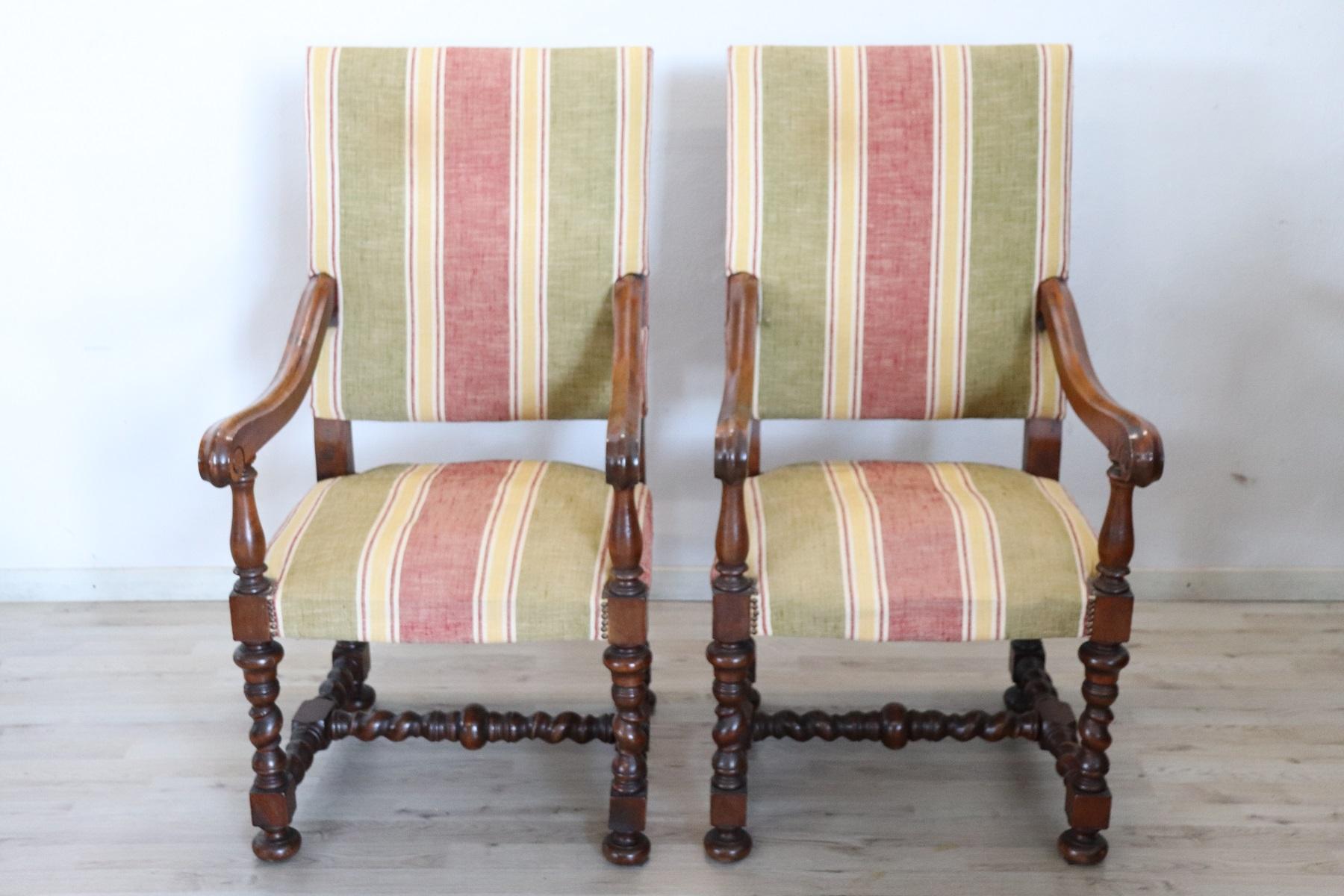 Italian Louis XIV style pair of armchairs very comfortable. Completely in slide walnut wood with refined turned decoration in the legs. The seat padding with defects, it would be necessary to restore. Fabric and wood in perfect condition.