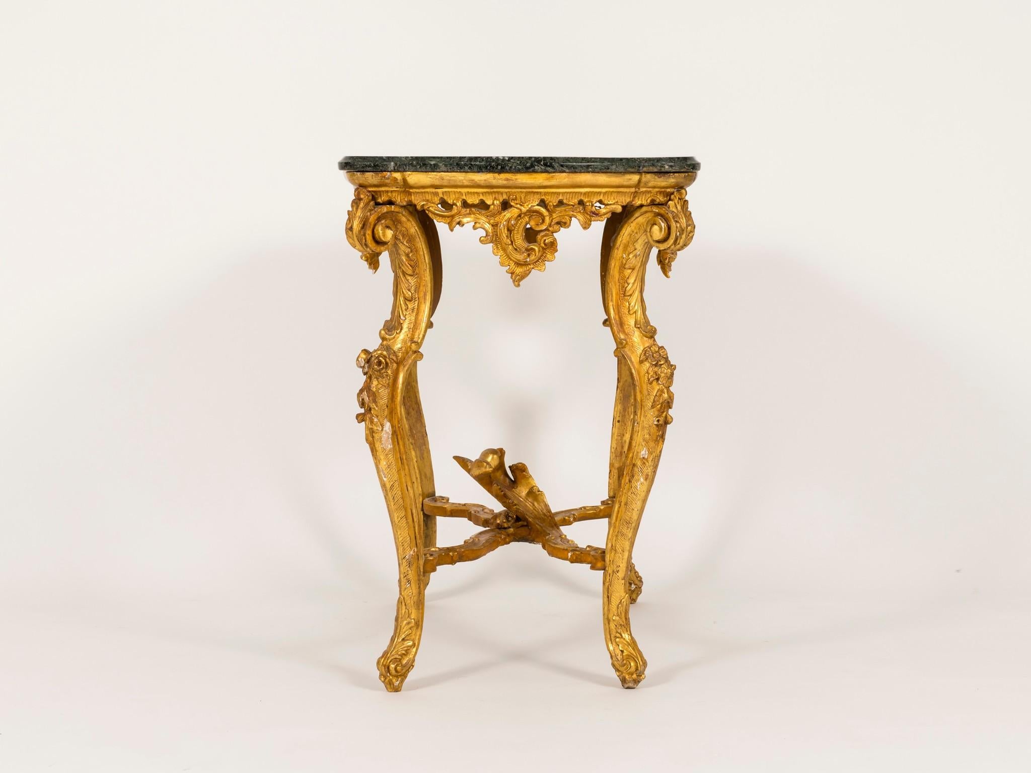 A 19th century Italian Louis XV style giltwood occasional table. This wonderful table features a green marble top, scrolled legs with floral and acanthus detailing.