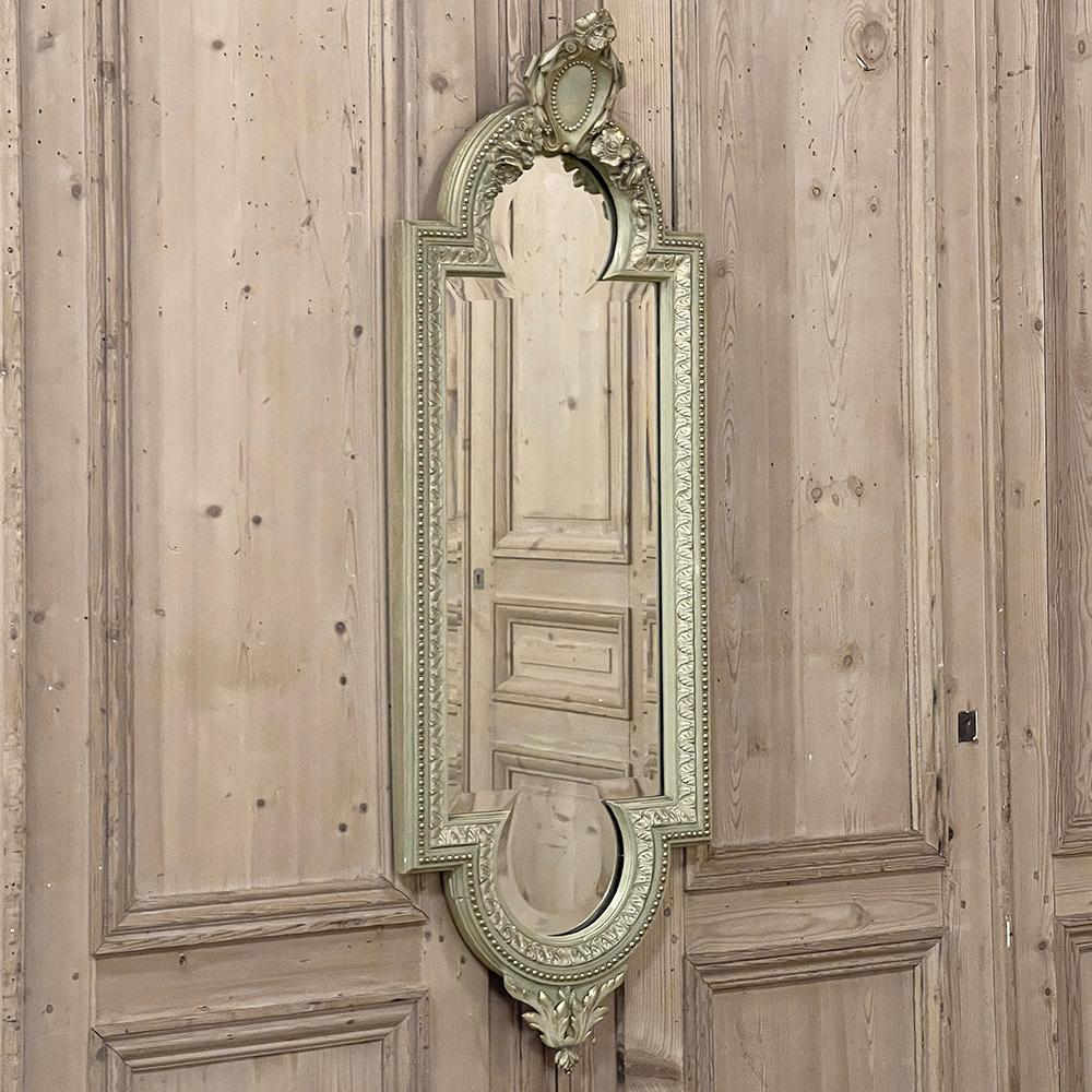 19th Century Italian Louis XVI Painted & Gilded Mirror was designed in an unusual vertical orientation with a narrow width that makes it ideal for special applications in a room.  Featuring its original painted finish that has achieved a lovely