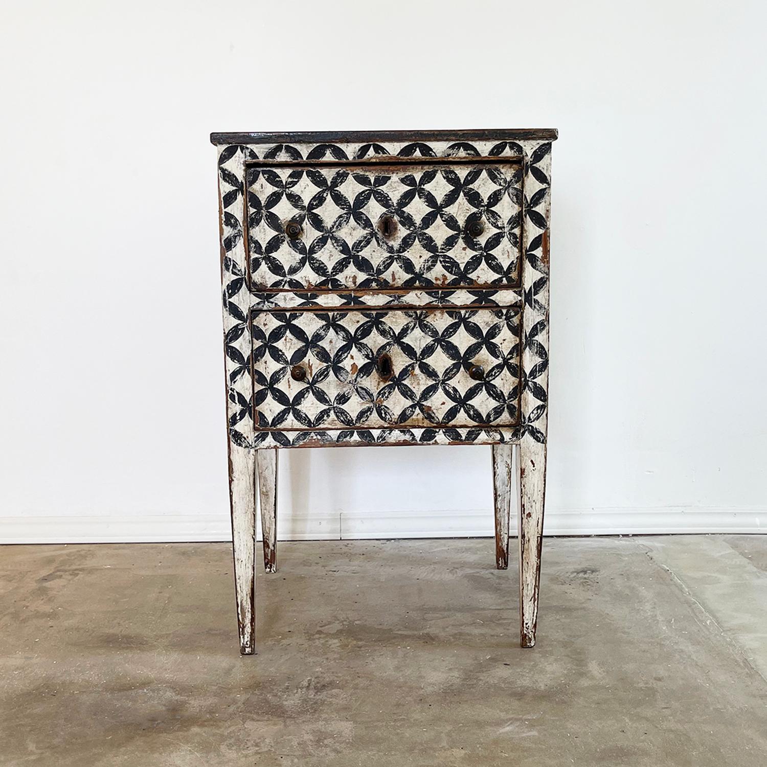 Late 19th Century, a Louis XVI small commode, Arte Povera, with two drawers and original knobs in legno laccato painted white-grey with a dark geometrical pattern. The detailed single nightstand, bed side table is made of hand crafted painted