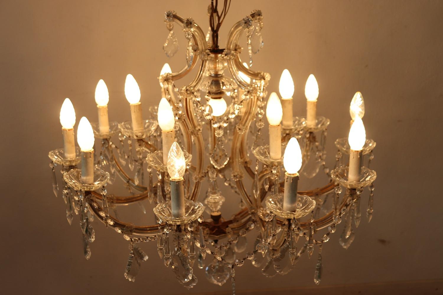 Beautiful and refined Italian Louis XVI style, circa 1880s chandelier sixteen lights. In bronze and completely covered drops of crystal. The crystal exudes the typical brightness; the drops are finely worked giving an elegant light. Chandelier of