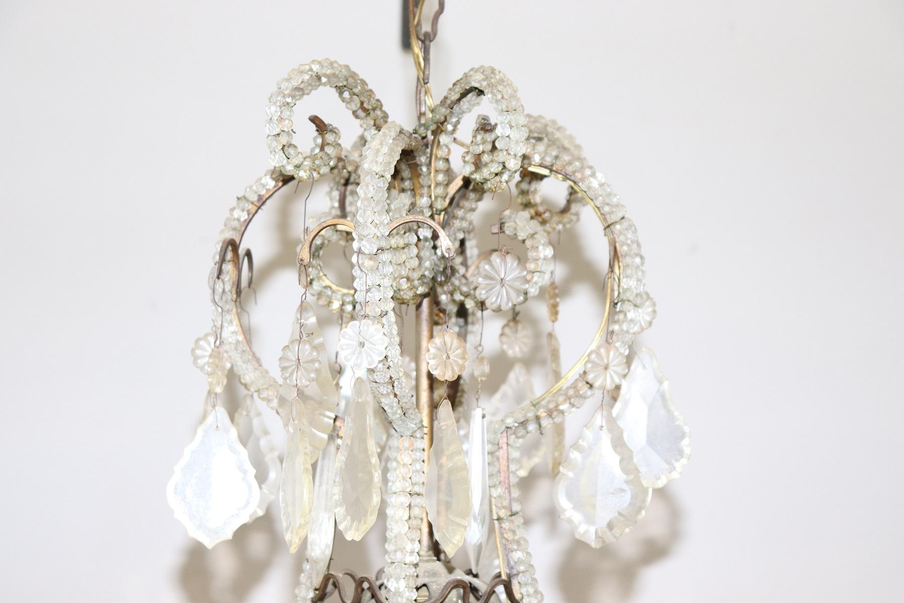 Beautiful and refined Italian Louis XVI style, circa 1880s chandelier nine lights. In bronze and completely covered drops of crystal Swarovski. The crystal exudes the typical brightness; the drops are finely worked giving an elegant light.