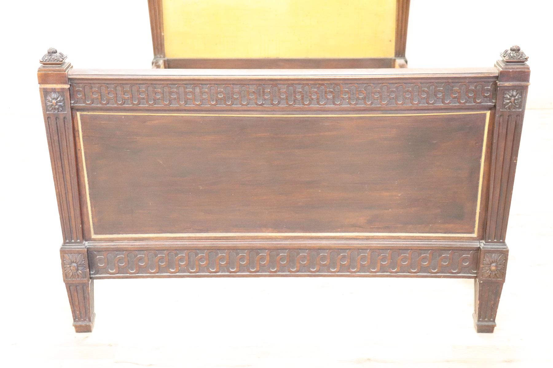 Beautiful Italian Louis XVI carved walnut bed. The bed is very linear with delicate carving in classic style. Precious small frames on the edges made of golden brass. Interior colored with yellow enamel which can be removed. Internal measures cm 200