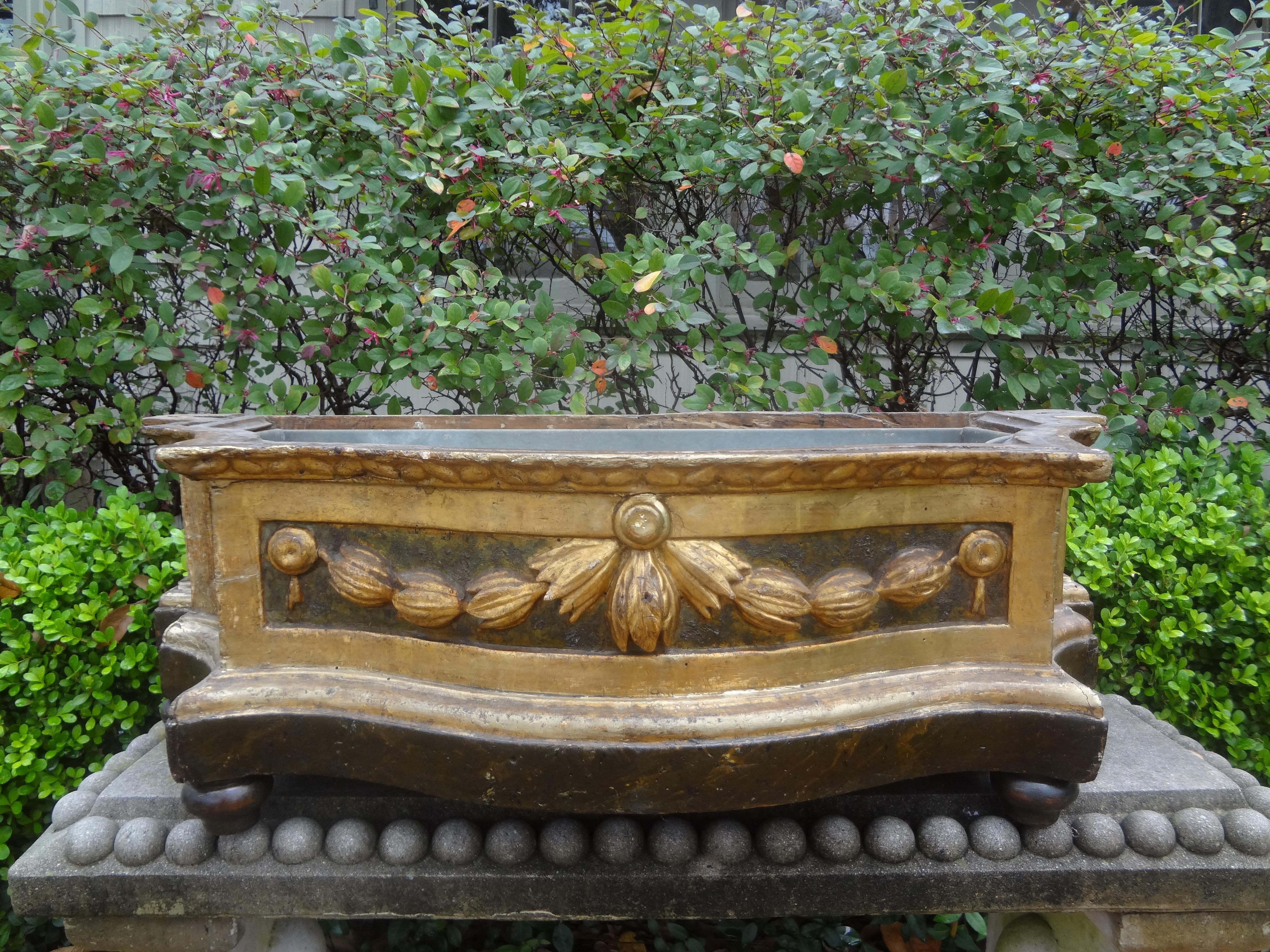 19th century Italian Louis XVI style carved wood planter.
Our elegant antique Italian Louis XVI style carved painted and parcel gilt planter, jardiniere or cachepot has a lovely draped design and retains
the original metal liner. Perfect dining