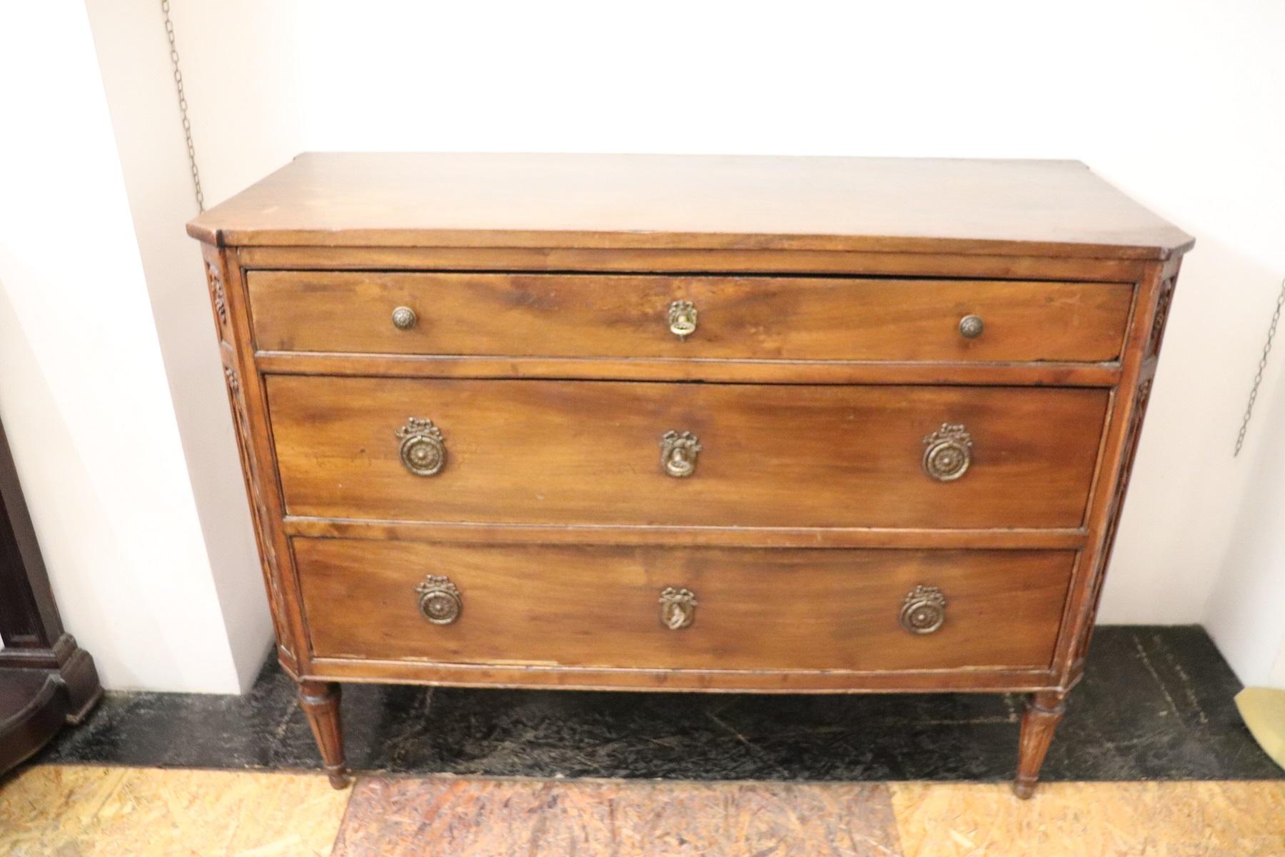 Important antique Italian Louis XVI chest of drawers 1780s walnut wood. The commode is very refined linear and elegant with straight feet and neoclassical taste decoration on the front. The decoration is carved in walnut wood. On the front two large