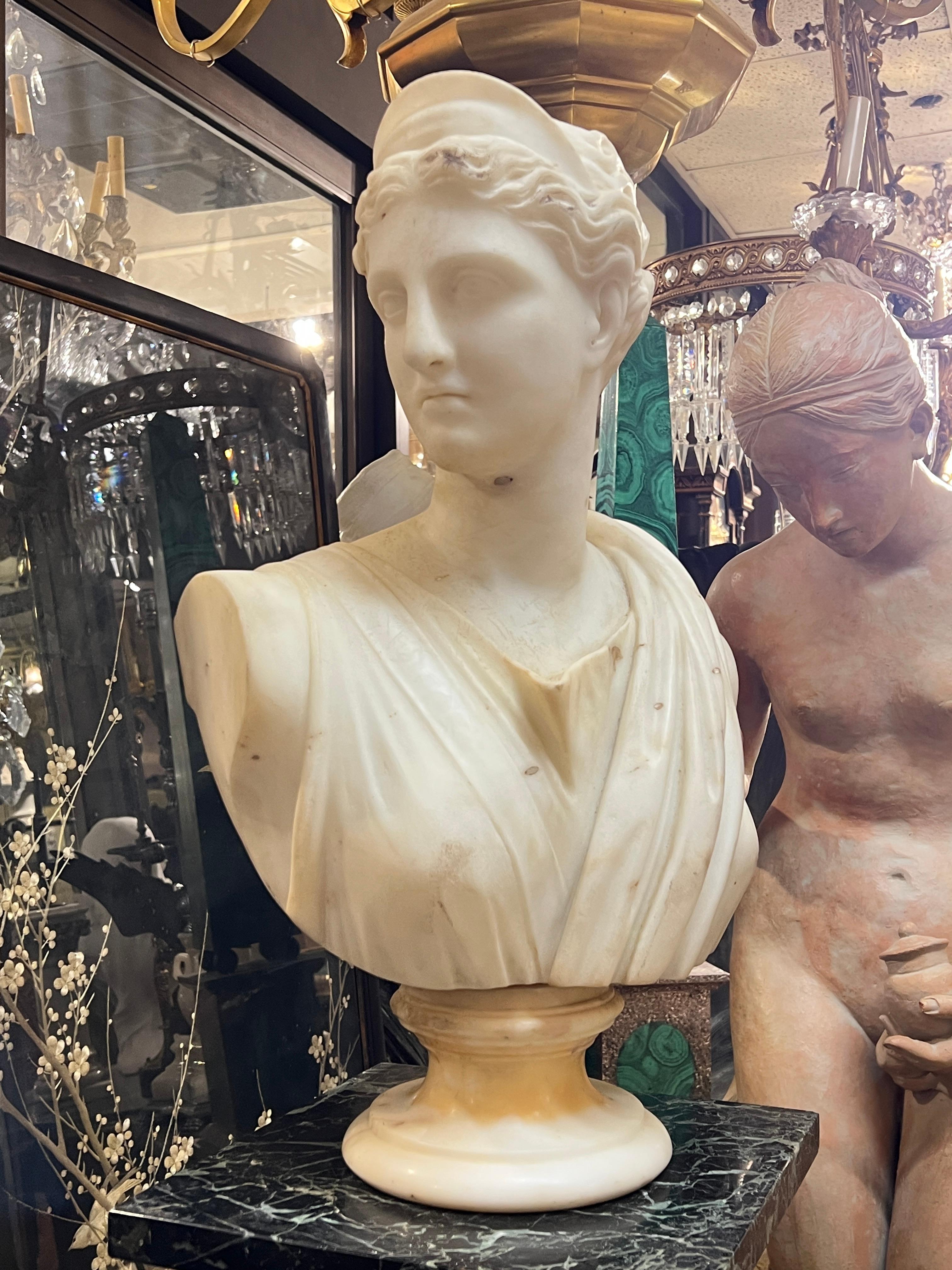 Antique (19th century) Italian white marble bust of the Roman Goddess, Diana, aka Artemis in Greek mythology, inspired by the Diana of Versailles, also known as Diana the Huntress, in the collection of the Louve.