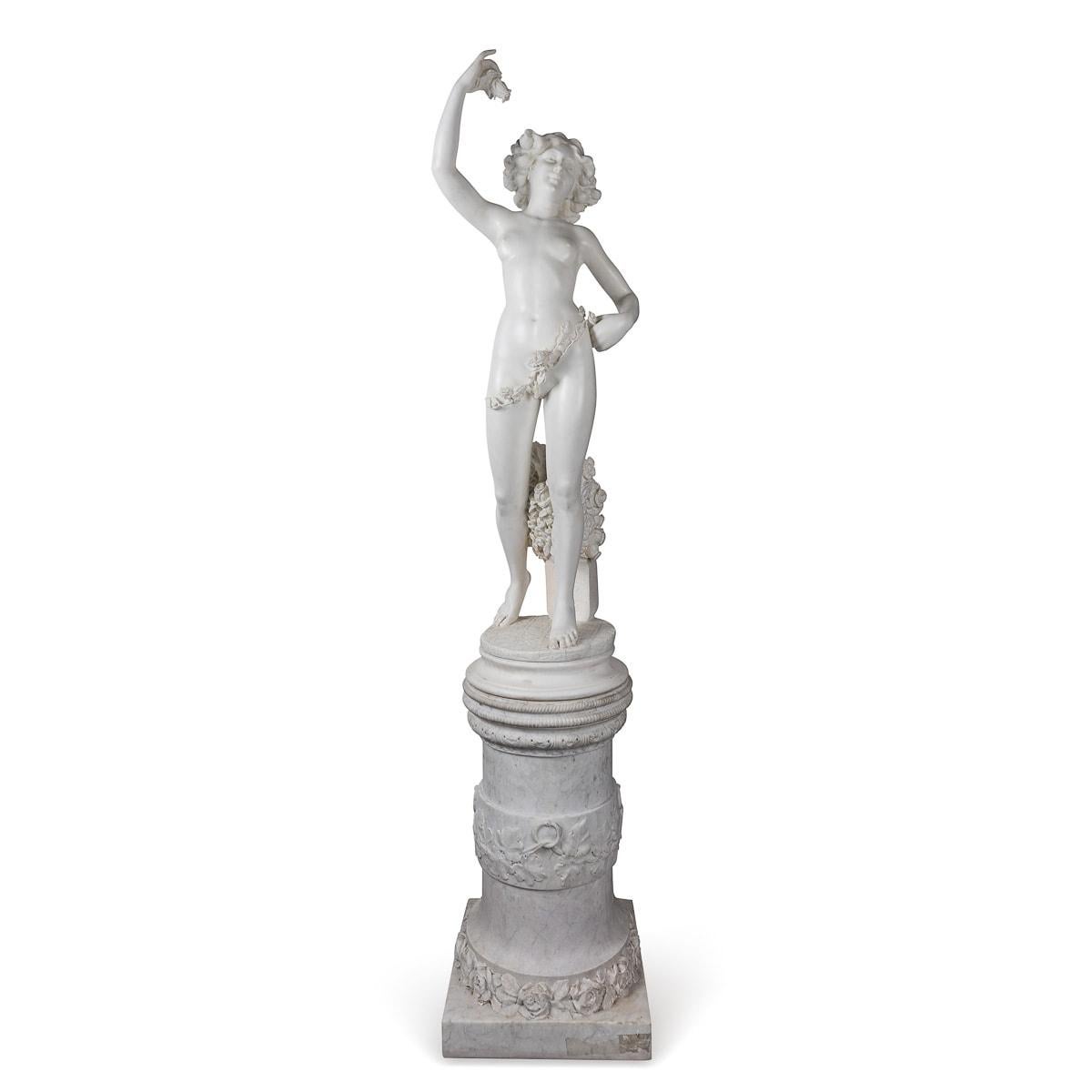 Crafted in the mid-19th century, this antique Italian marble sculpture portrays a graceful nude lady draped with flowers. Delicately holds up a small flower in one hand, while the other hand rests on her hip, below her feet a cornucopia of flowers,