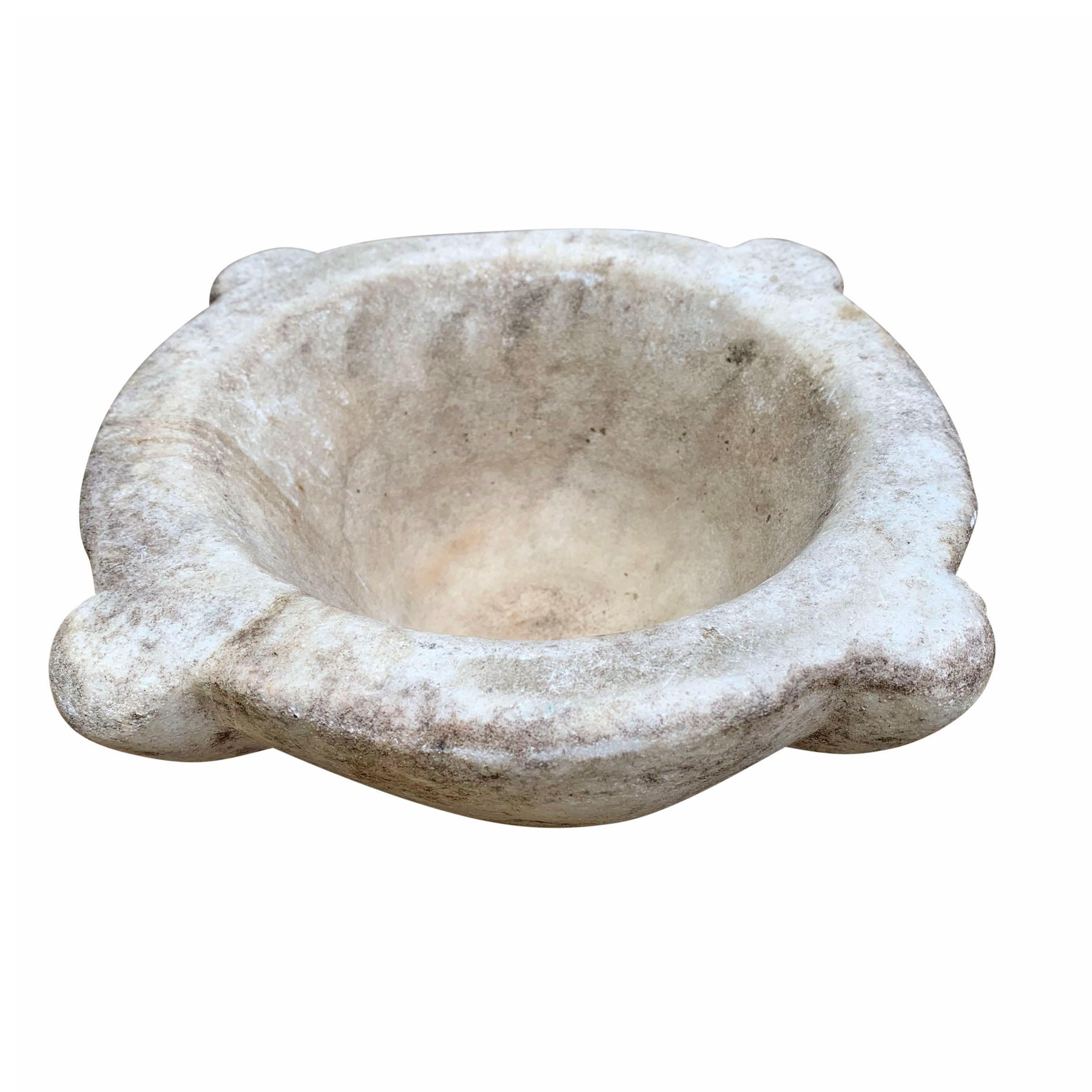 A wonderful 19th century Italian carved marble mortar originally used to make pesto, now perfect for keeping your salt and pepper at arm’s reach, crushing other herbs and spices, or serving chips at your next fête.