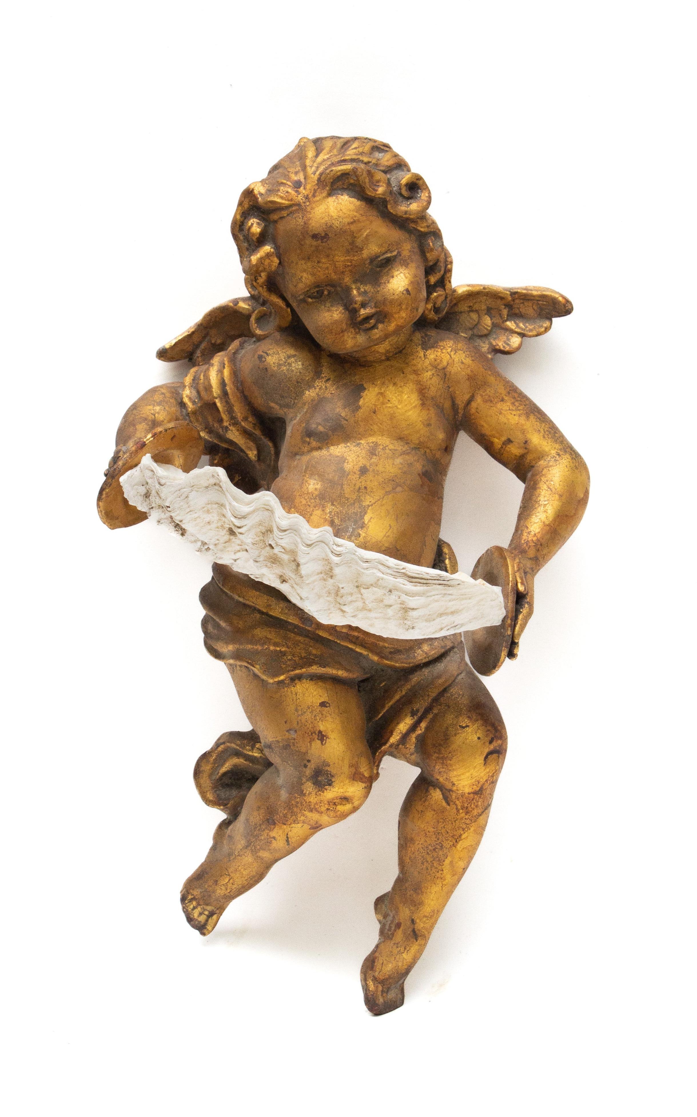 19th century Italian hand-carved gold leaf mecca angel holding a clam shell and adorned with baroque pearls.

Angels and cherub figures frequently appear in both mythological and religious paintings and sculptures, especially of the Renaissance and