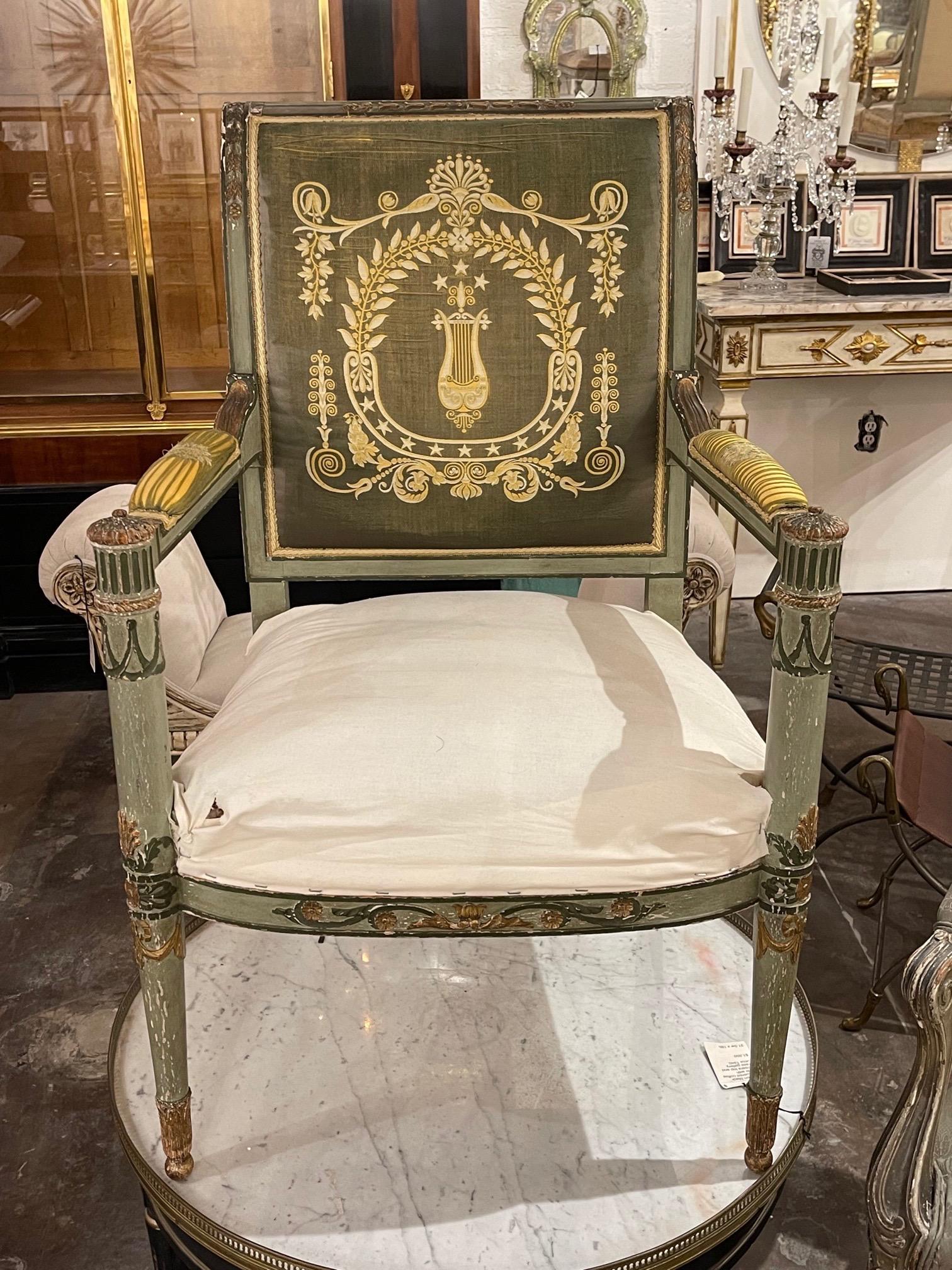 Decorative 19th century Italian Neo-Classical style carved and painted arm chair. Painted in shades of green and gold with a beautiful upholstery on the back. Adds a reach touch of elegance!