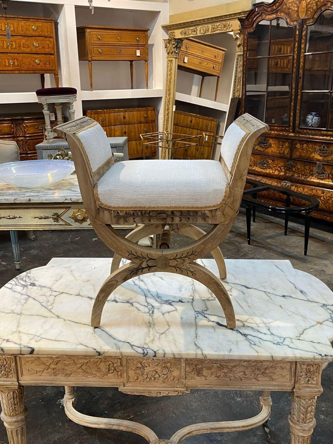 Elegant 19th century Italian Neo-Classical style x form carved and bleached bench. Upholstered in a beautiful neutral creme fabric. Exceptional quality. So pretty!!