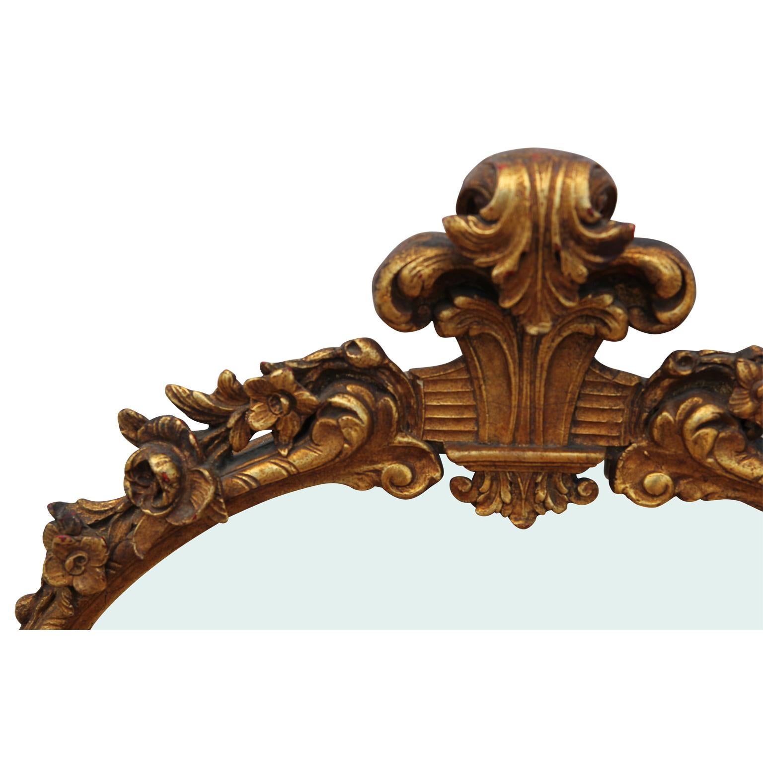 Beautifully gold leafed mirror in the style of a 19th century Italian neoclassical La Barge mirror. The ornate filigree accents add an element of opulence to the design.
