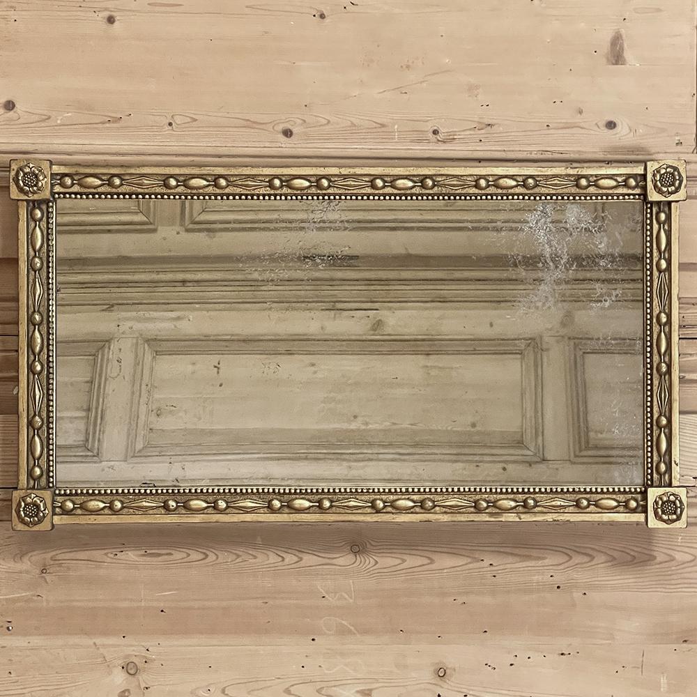 19th century Italian neoclassical mirror features an intriguing framework design alternating between oval egg forms and diamond forms separated by beads, with a separate smaller beading immediately adjacent to and surrounding the glass. Four