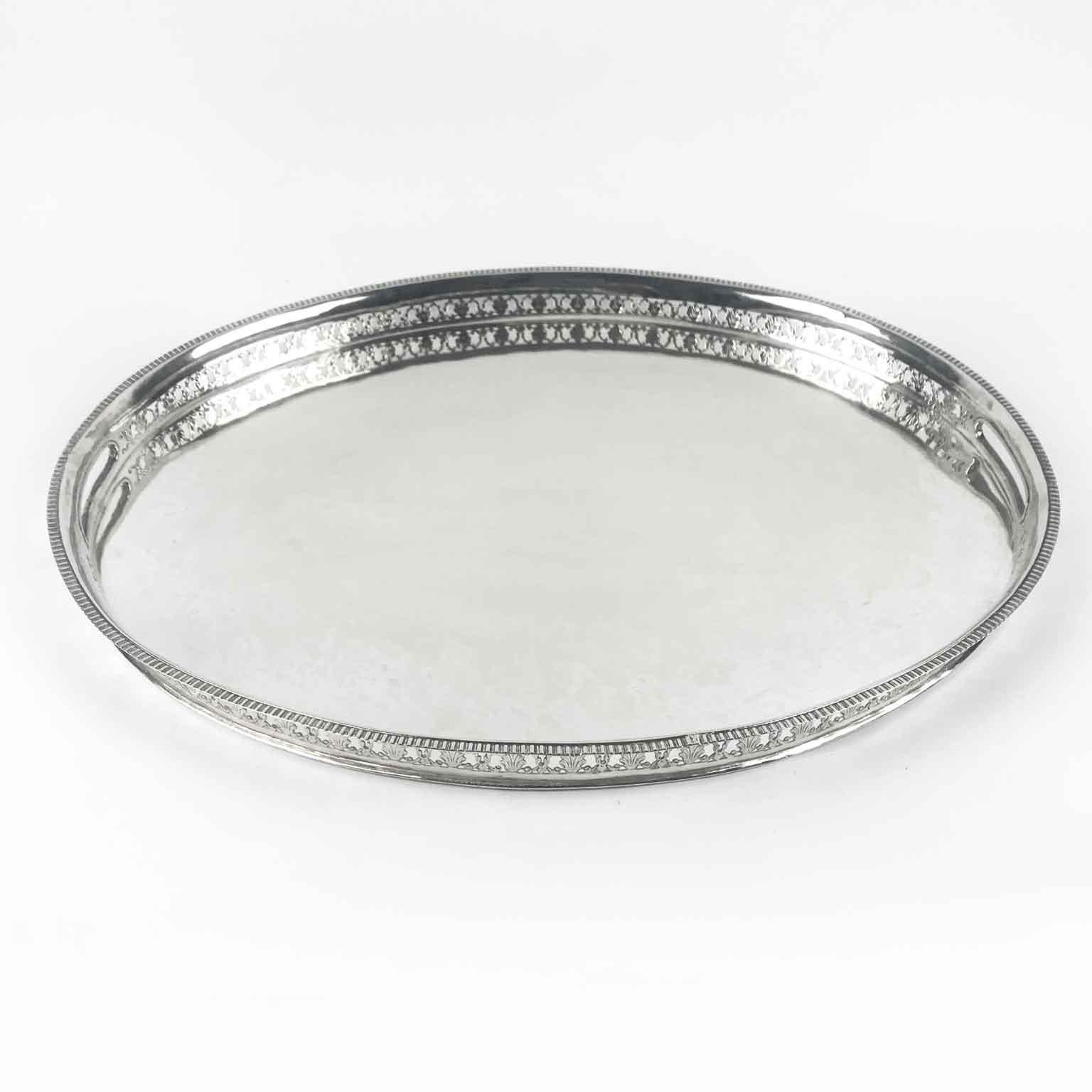 A lovely Italian Venetian silver tray, a neoclassical oval shaped silver tray with a 3 cm tall border going around dating back to the first quarter of 19th century. Weight: 1525 grams.

The border has a pierced design and it is hallmarked with
