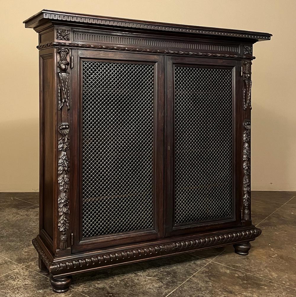 19th Century Italian Neoclassical Walnut Barrister's Bookcase features hand-sculpted brilliance in a compact package that makes it easy to access the books while still seated at one's desk. Stamped brass wire mesh adds an elegant detail, allowing
