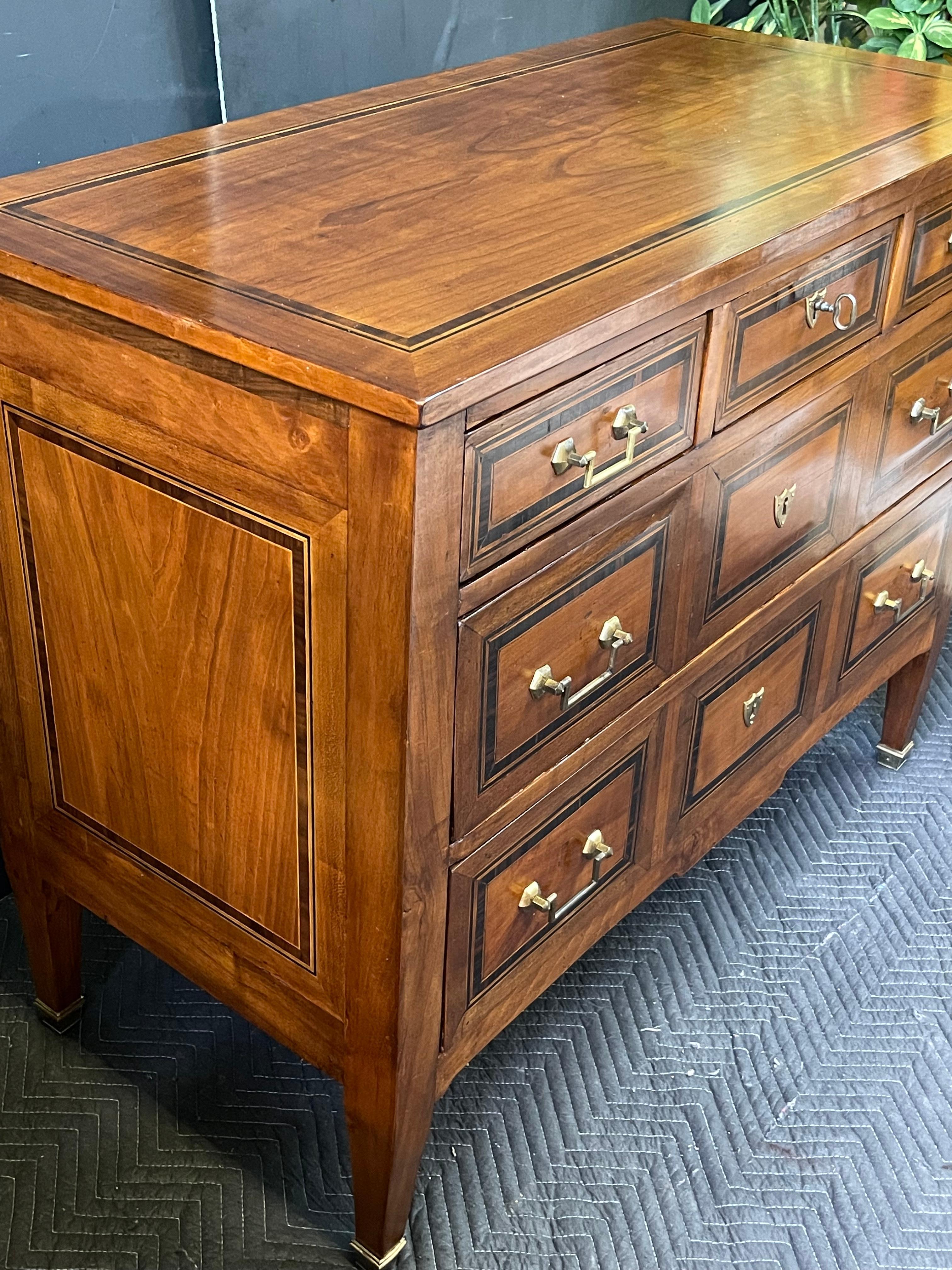 19th Century Italian Neoclassical five drawer chest or commode styled in the manner of Directoire. The burled wood top and paneled sides have a beautifully detailed inset inlay surrounded by a banded outer edge. A solid and symmetrically designed