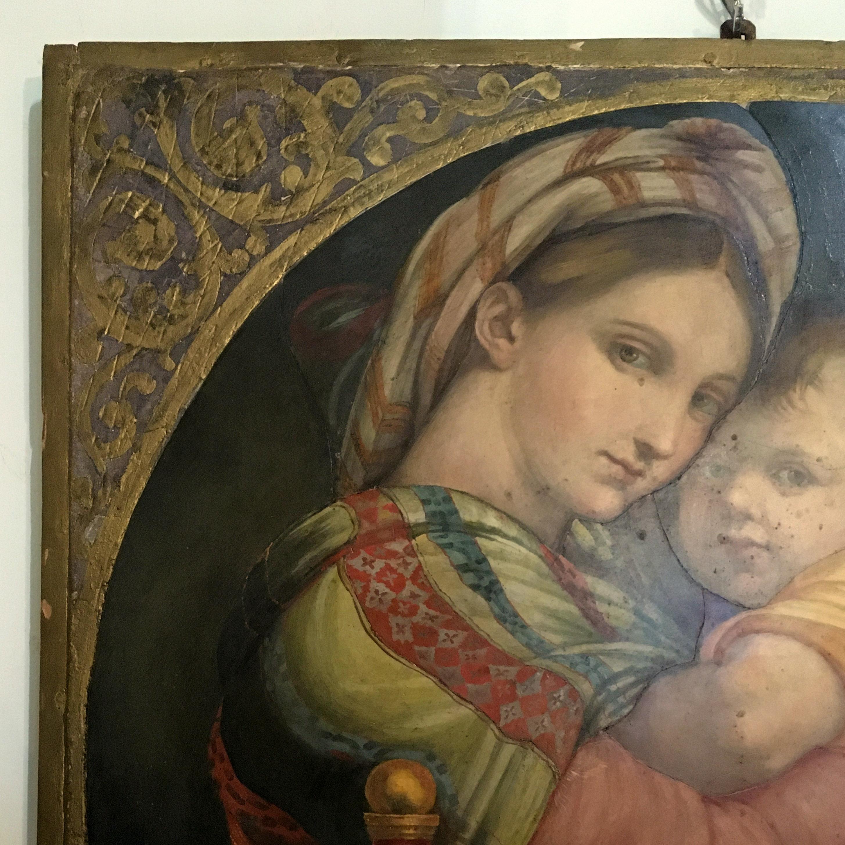 This beautiful oil on wooden panel painting depicts a Madonna with bambino and Saint John the Baptist.
The painting is actually a copy of a famous painting by the Italian Renaissance artist Raphael, the 