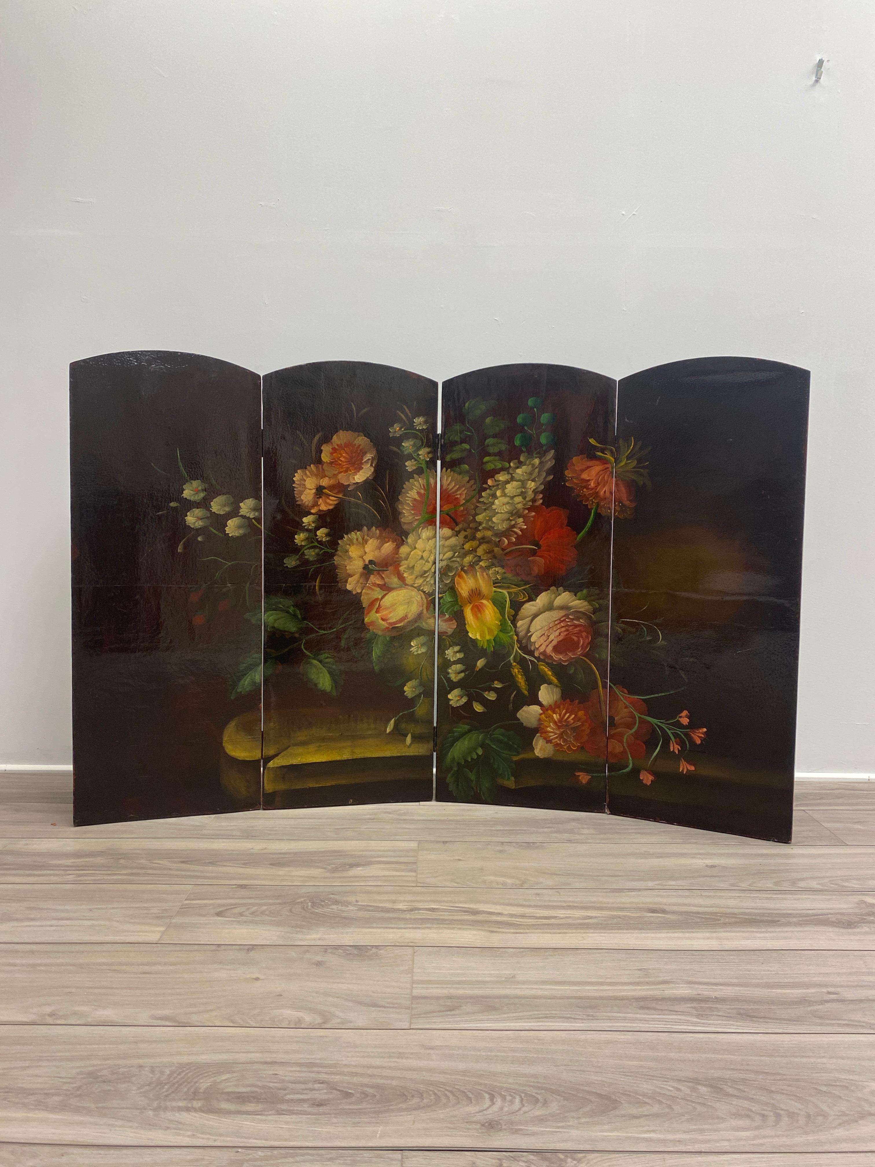 Late 19th century Italian screen with a gorgeous oil painting of floral scene. The oil paint colors are vibrant and in good condition. The frame is made of canvas over a wooden frame with four hinged panels rectangular with arched tops.