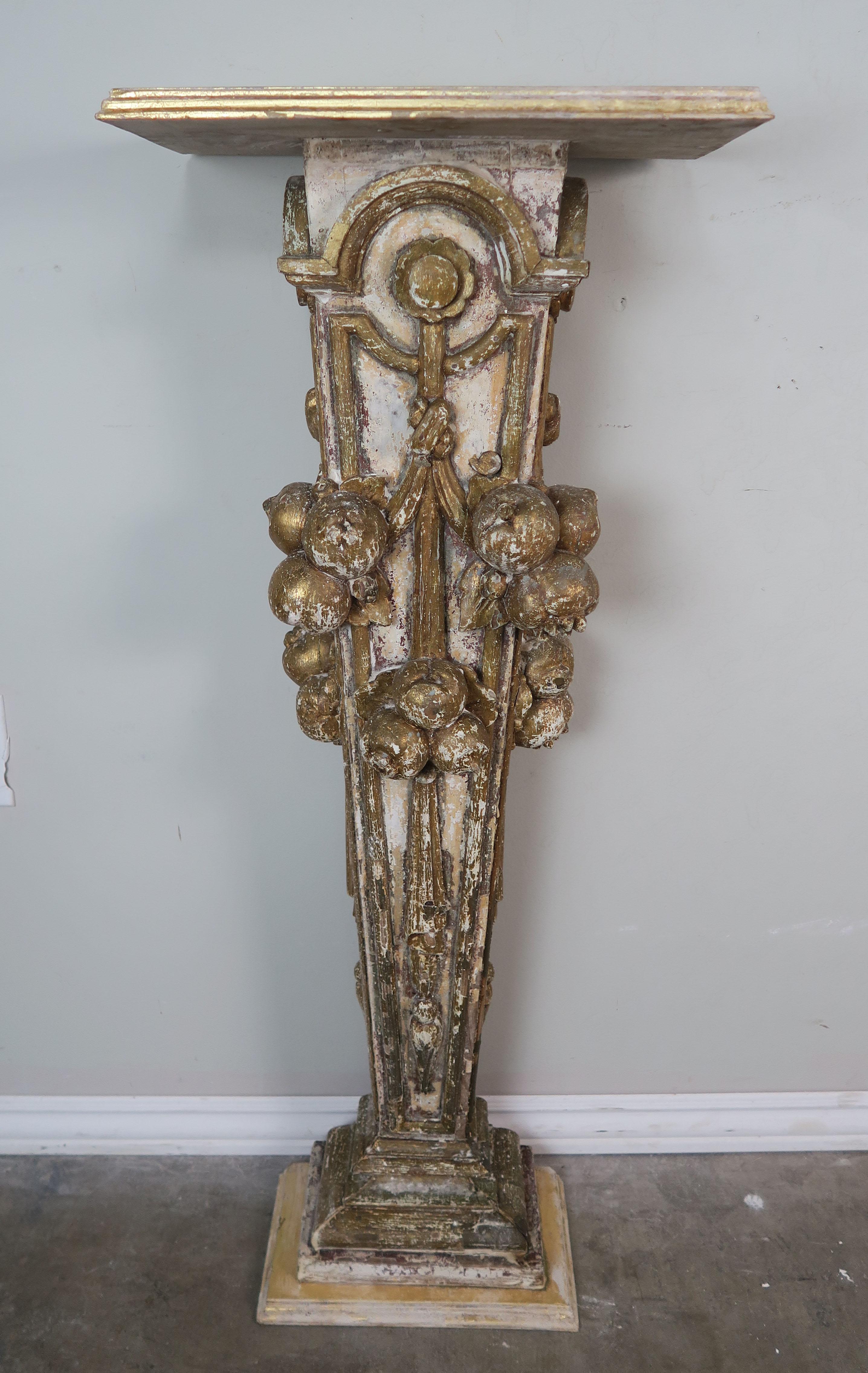 19th century Italian painted and parcel giltwood pedestal table depicting carved fruit and garlands.