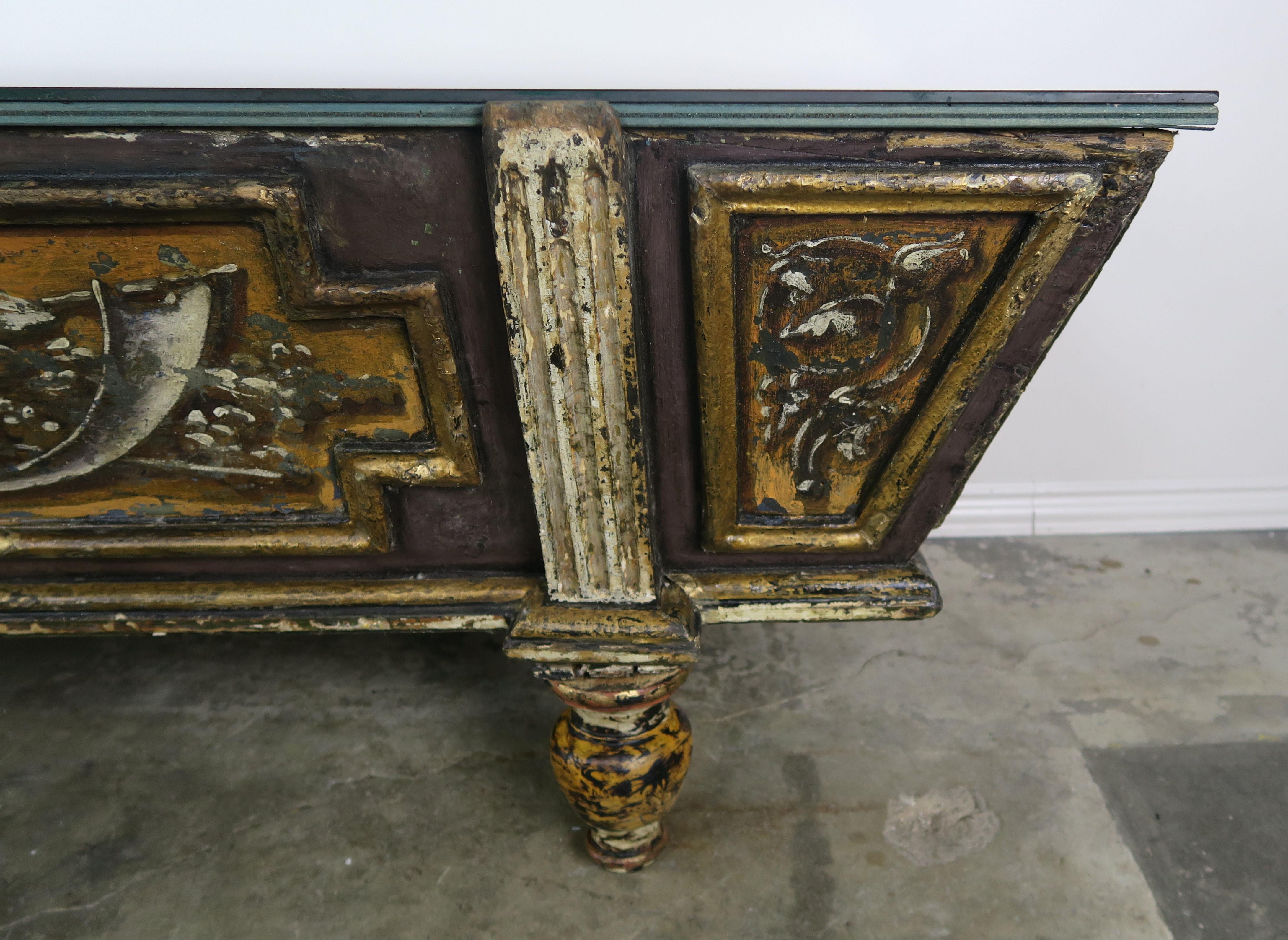 19th century Italian painted cassone that has an antiqued mirrored top. The top opens to provide great storage inside. The original paint depicts winged figures, flowers, and architecture throughout.
