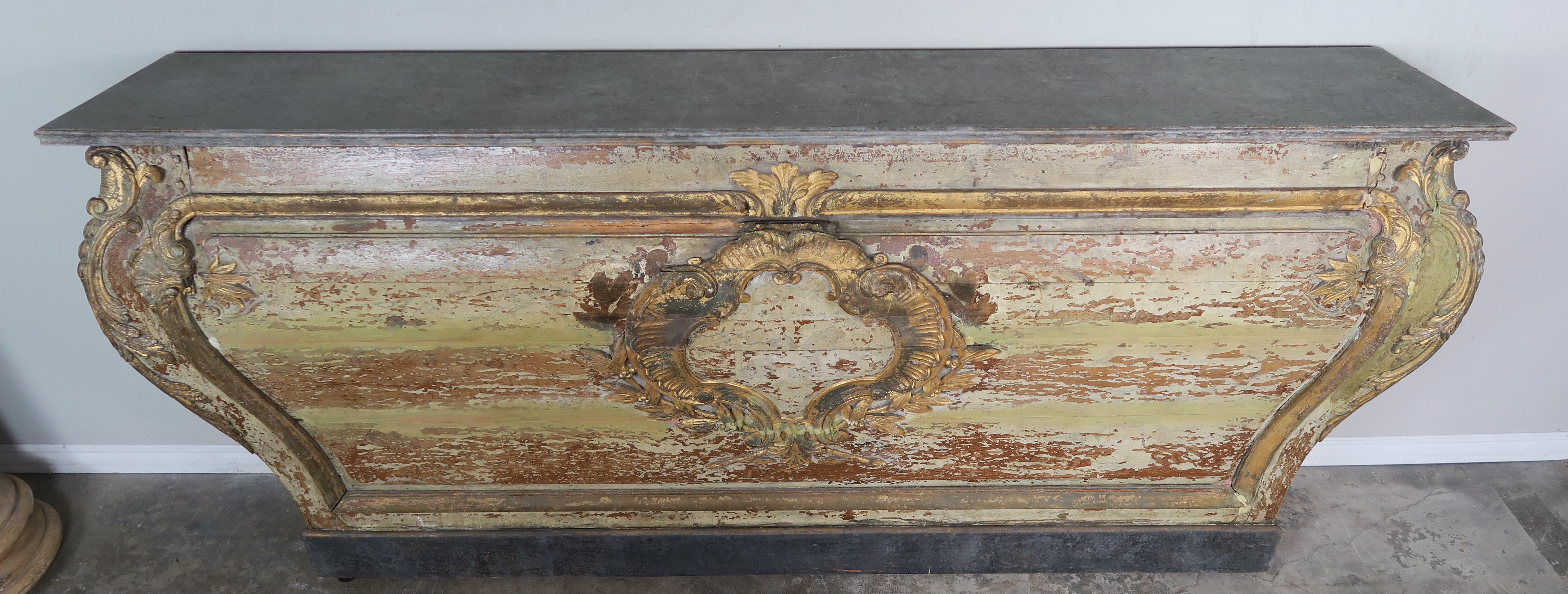 19th century Italian painted console with centre cartouche. Remnants of paint in golds, creams and rust can be seen combined with gold leaf accents.