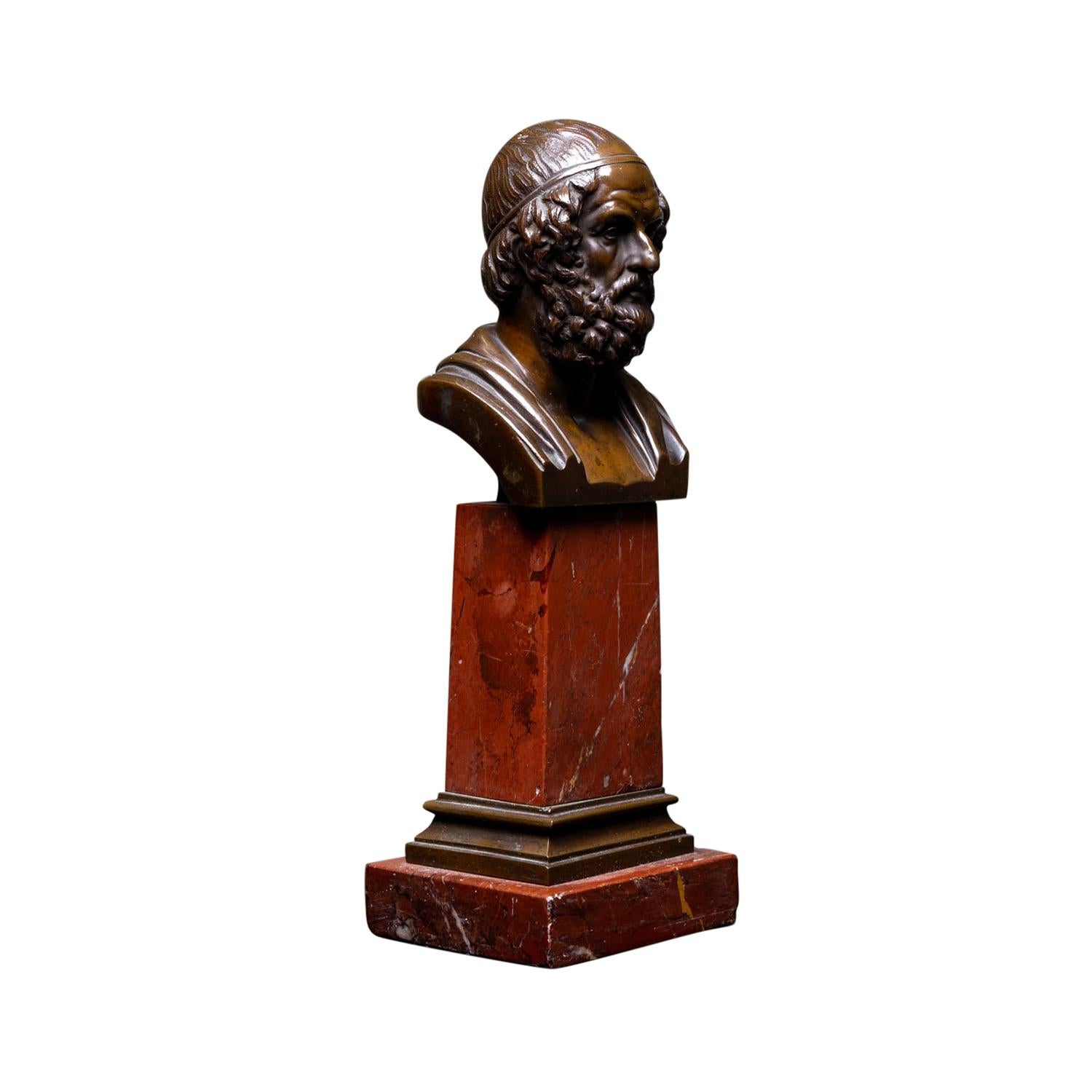 A small, antique Italian pair of busts of Homer made of hand crafted bronze, in good condition. The décor sculptures are resting on a red stone base. Minor fading, scratches due to age. Wear consistent with age and use. Circa 1860 - 1880,