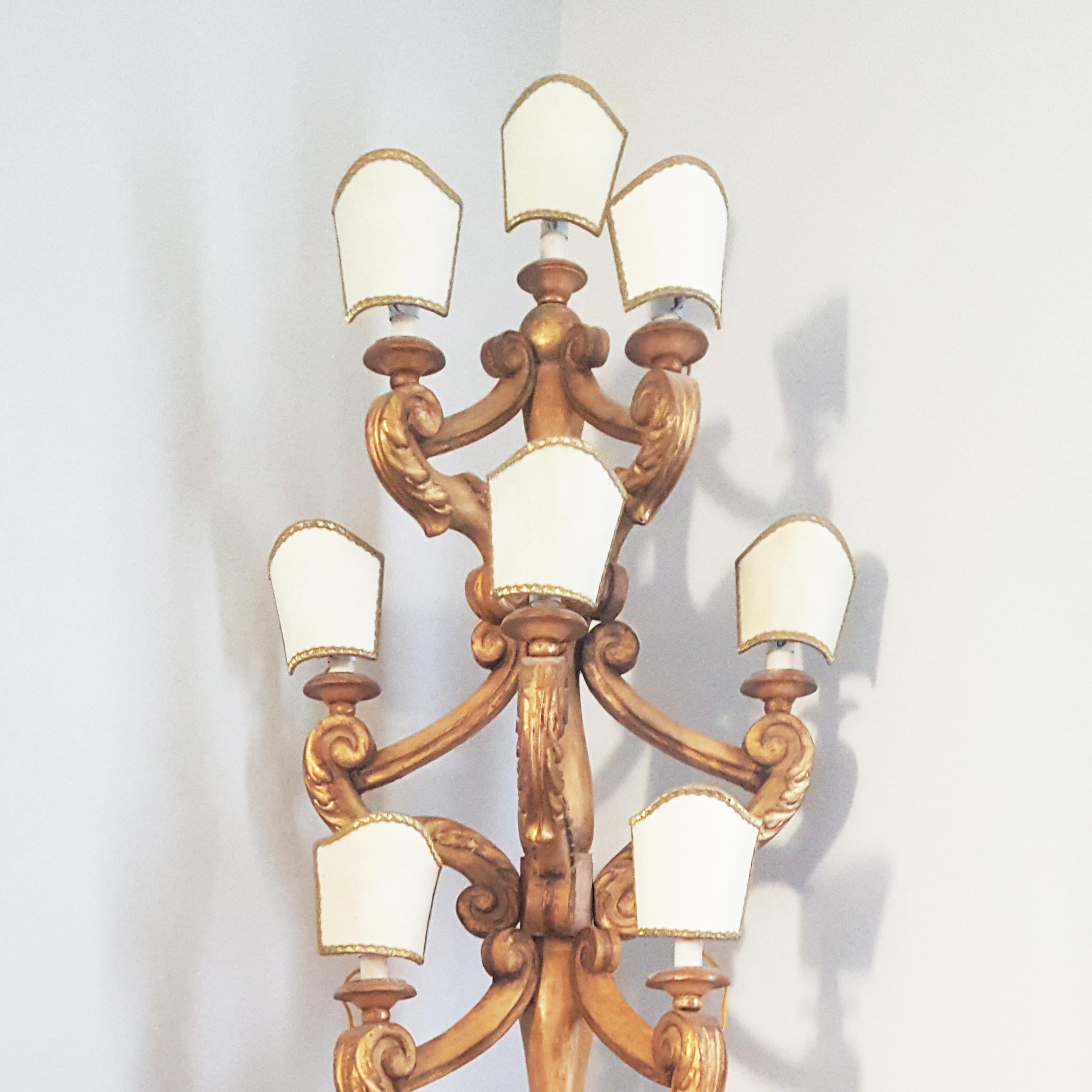 A charming pair of Tuscan candelabras in painted and gilt poplar wood.
Each candelabra is electrified and presents eleven lights covered by elegant parchment paper lampshades.
Tuscan manufactory from the 19th century.
  