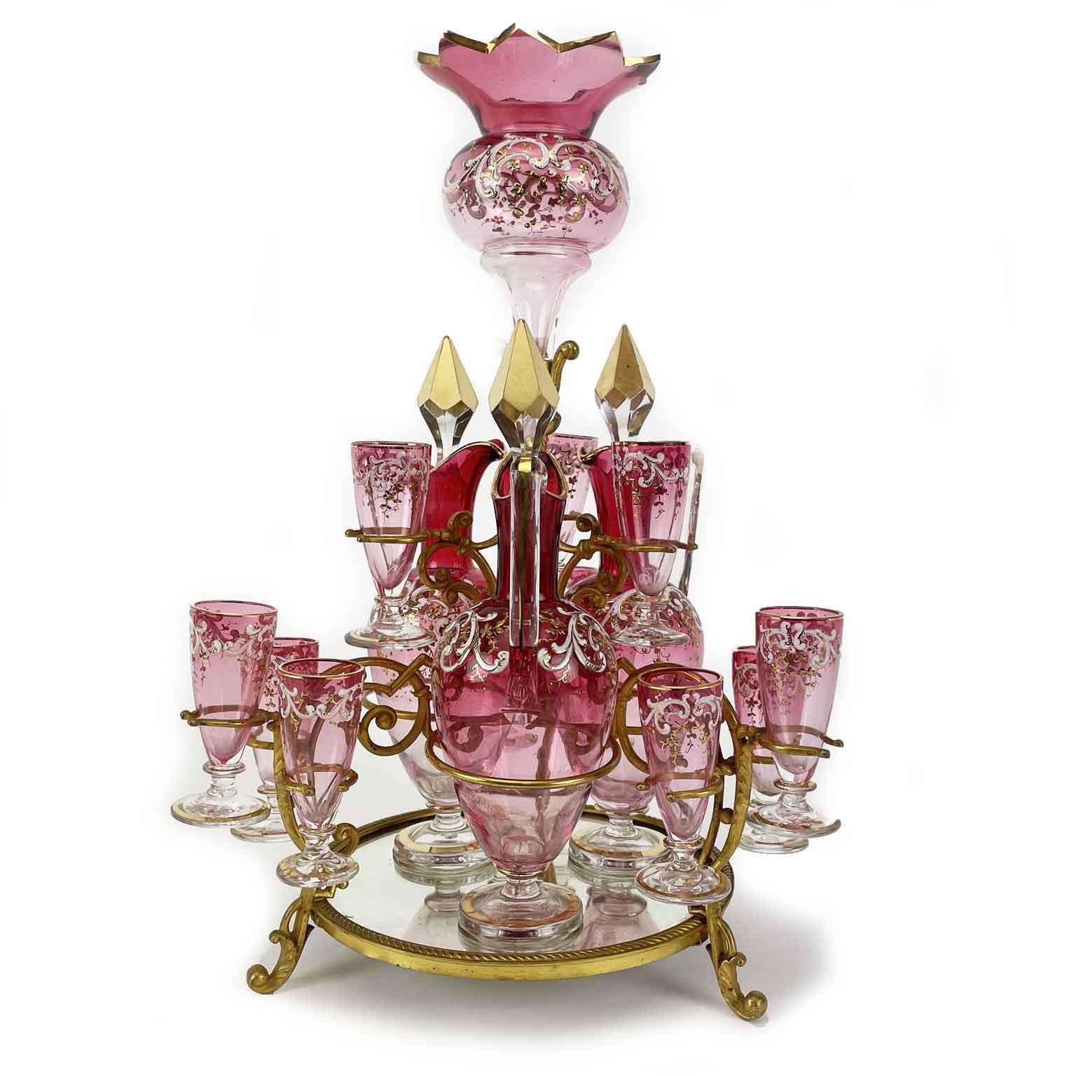 Antique late-19th century Italian exquisite glass liqueur set, consisting of three liqueur bottles, 3 decanters with stoppers, twelve small glasses arranged on two tier. This antique Italian tantalus has a circular pyramidal frame, an elegant gilt
