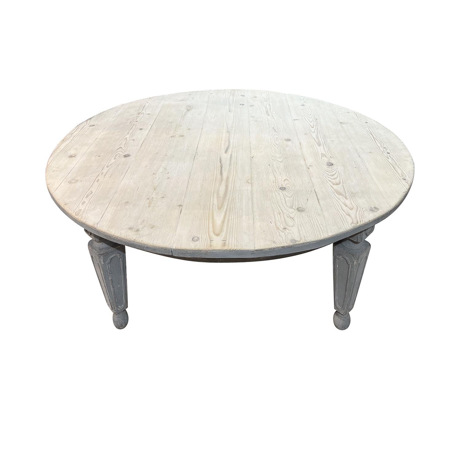 A 19th Century, antique large round dining room table made of hand crafted painted Pinewood, in good condition. The Tuscan conference table is standing on four detailed carved wooden legs, particularized with its original grey-blue patina, the table