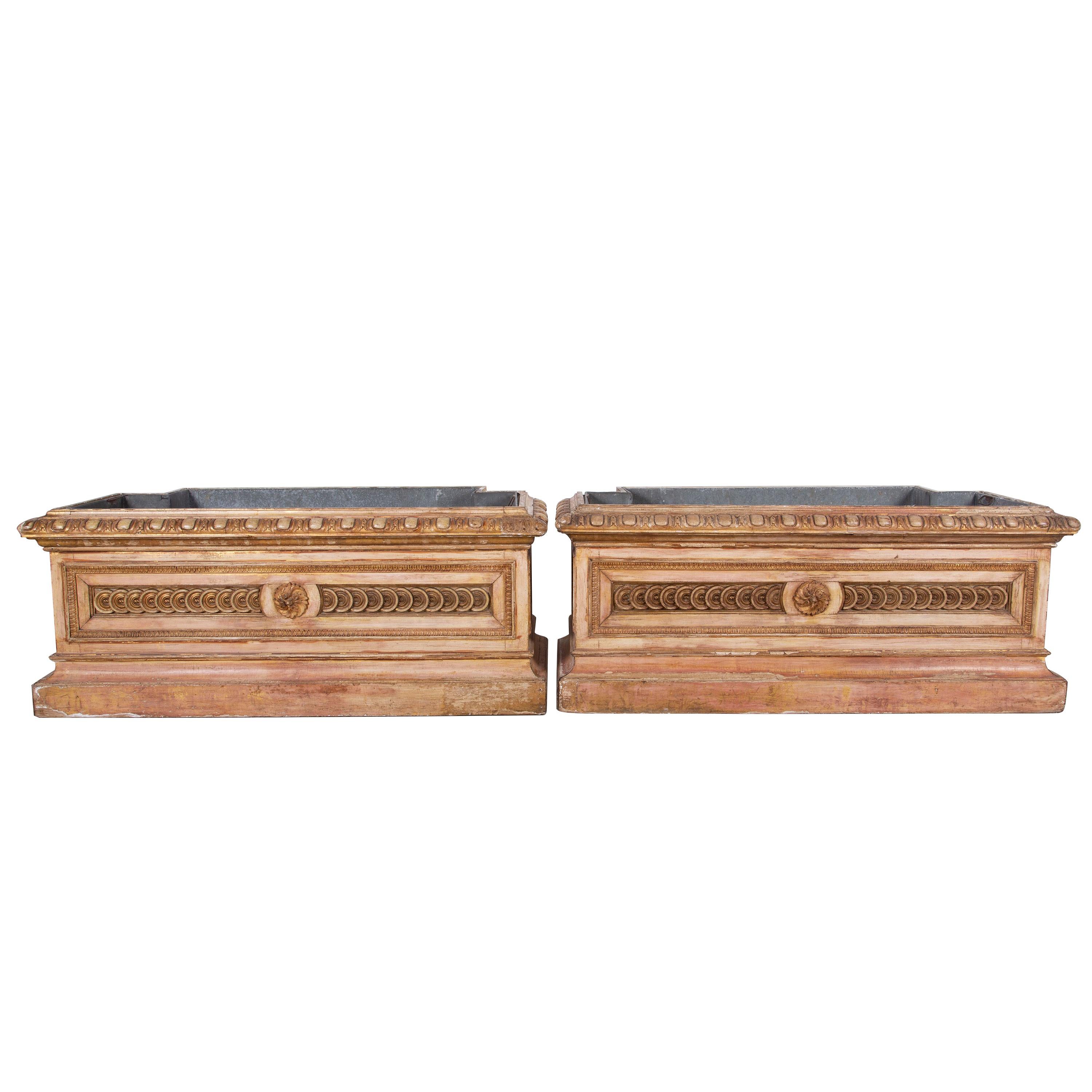 A statement pair of rare and highly decorative late 19th century Italian planters in the Directoire style with original zinc lining and beautiful repeated carved panels to the front and sides.