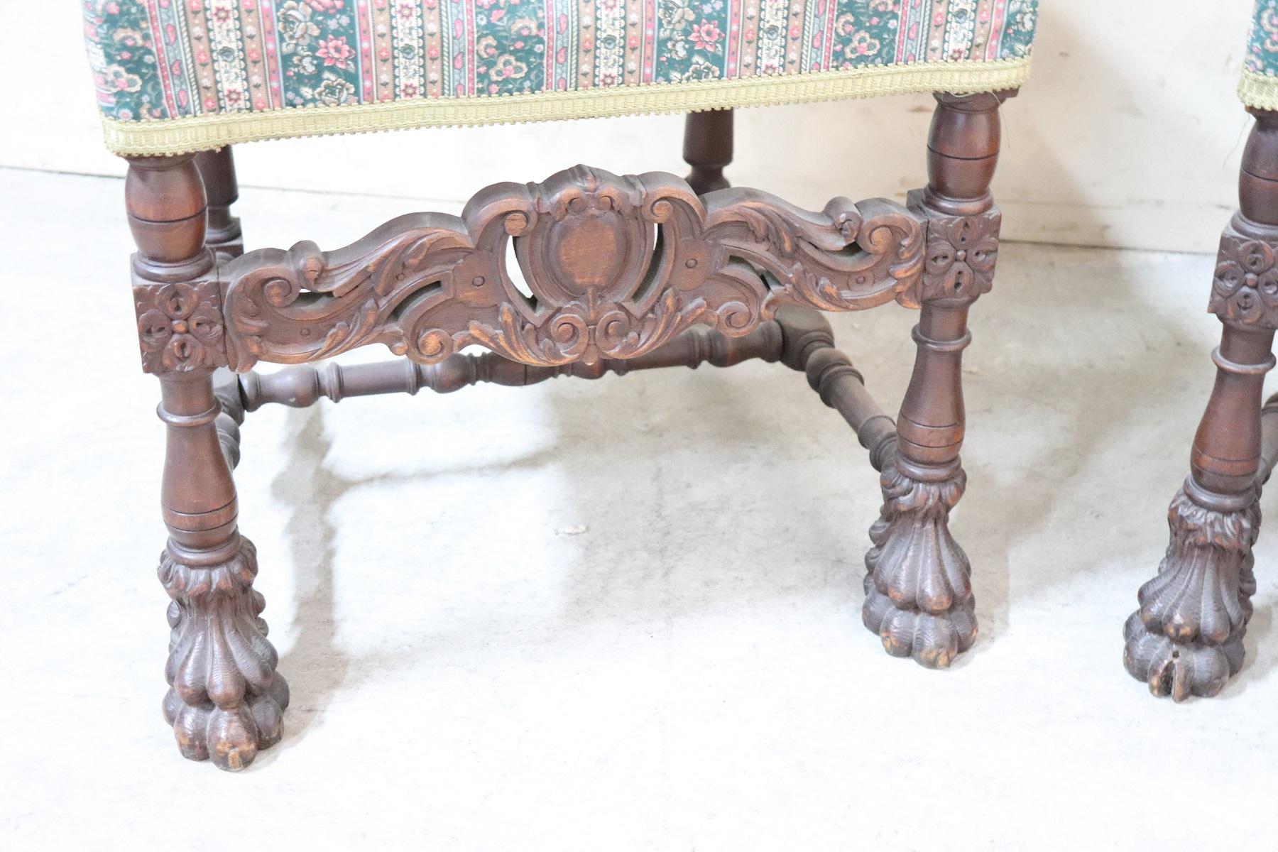 Impressive rare pair of throne chairs in perfect Italian Renaissance style. Made of solid walnut wood. The finely carved wooden backrest with very complex decoration. The armrests and legs are in turned solid walnut. particular lion's paw feet