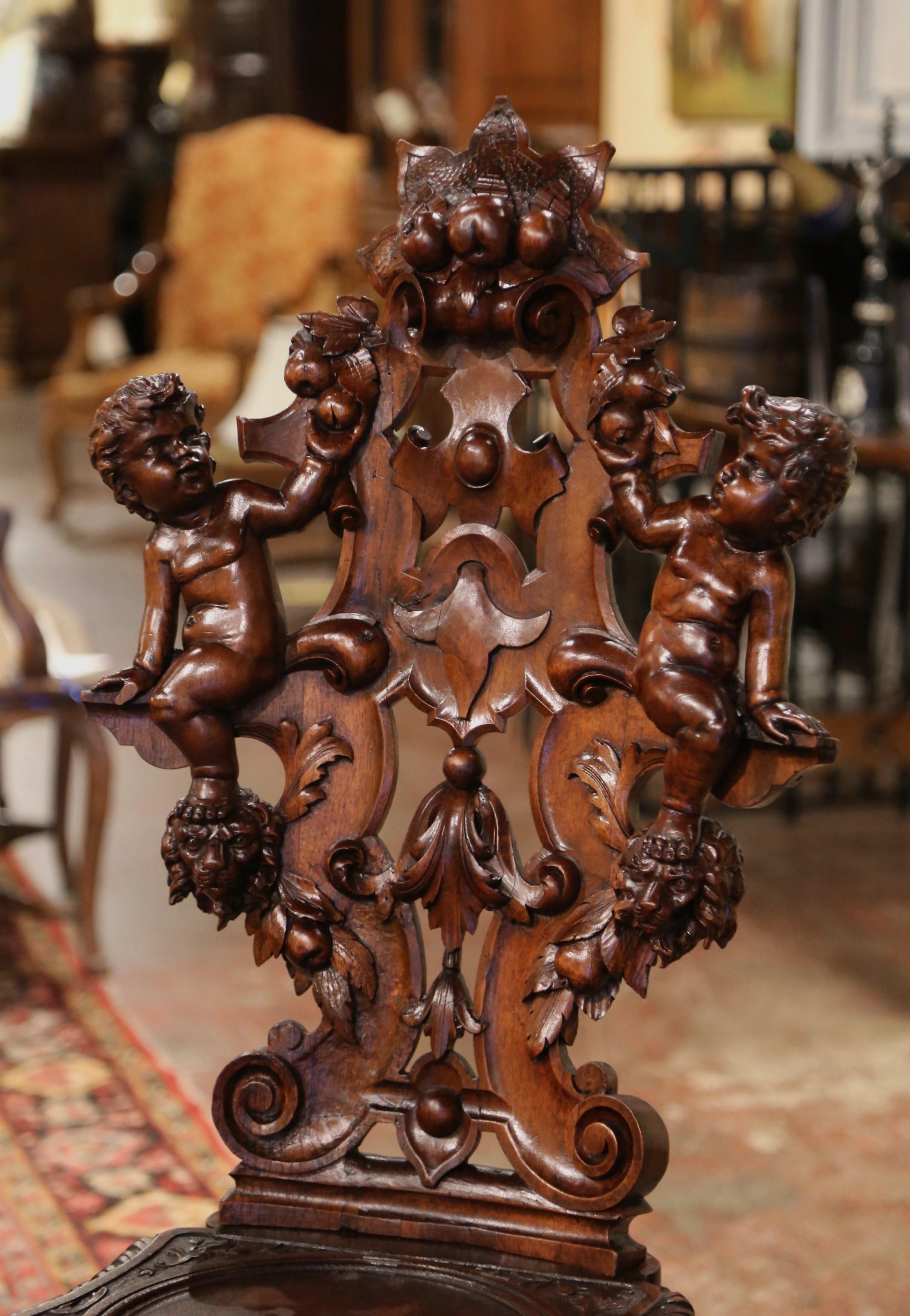 Patinated 19th Century Italian Renaissance Carved Walnut Sgabello Hall Chair with Putti