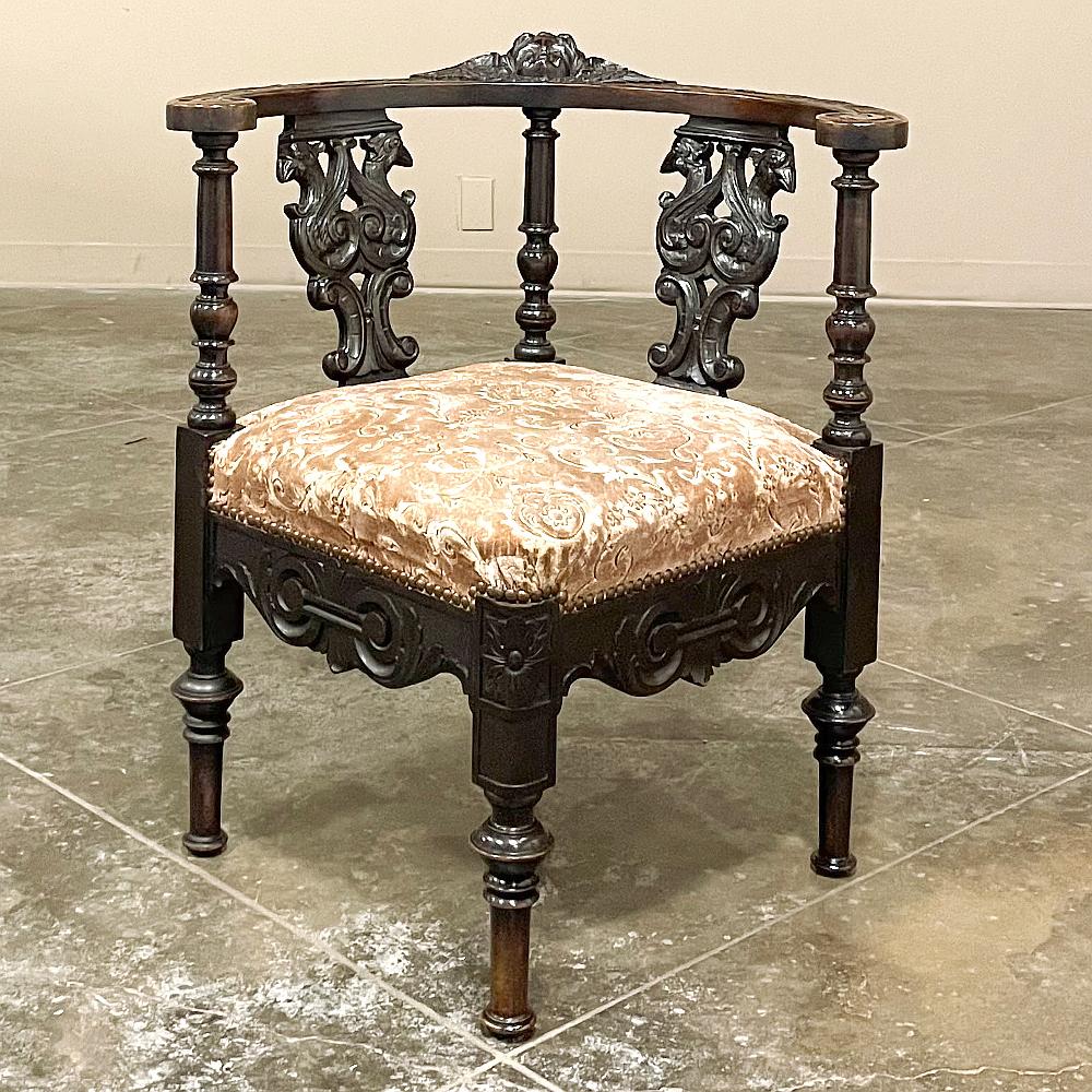 19th Century Italian Renaissance corner armchair was designed to take advantage of an otherwise unused space in the corner. Sculpted from solid walnut, it features a semicircular armrest supported by three turned uprights between which have been