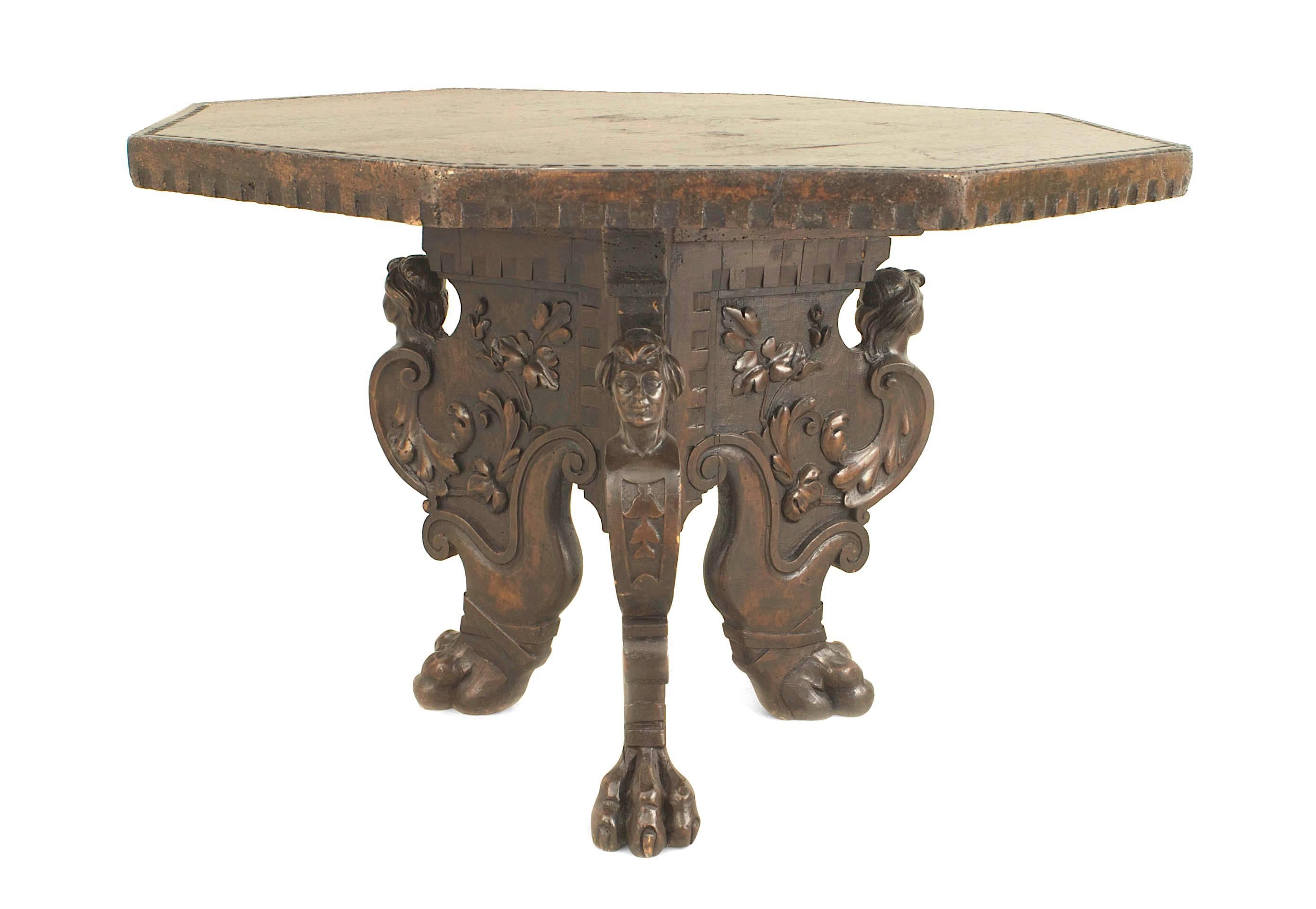 Italian Renaissance Revival (19th Century) walnut octagonal top center table with a carved edge and supported on a carved tripartite base with claw feet.
