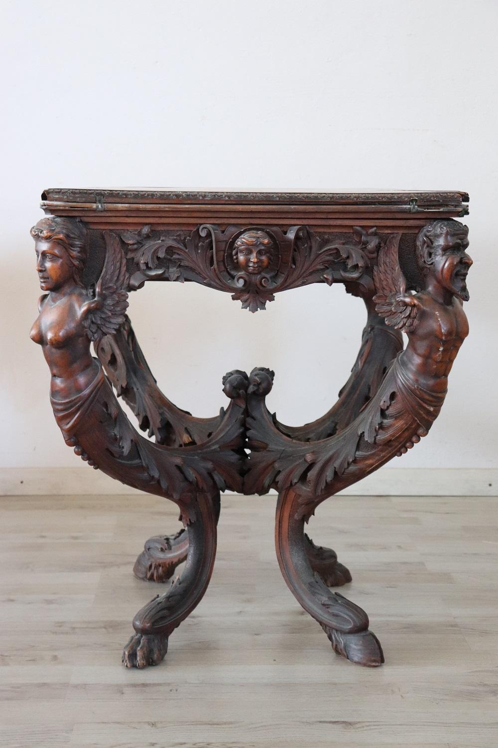 Rare beautiful antique game table in precious hand carved walnut wood. When the table is closed, the table becomes smaller and can be used as an elegant center table. This majestic table features high artistic quality carving work. The rich