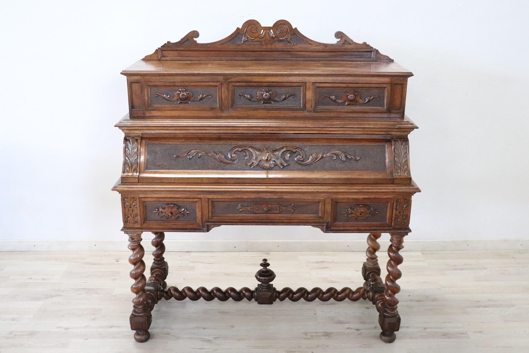 Majestic antique Italian renaissance style writing desk. Rare and precious solid carved walnut wood. Comfortable size for a practical use. The desk has elegant turned legs. Equipped with six practical drawers. The front opens and becomes a