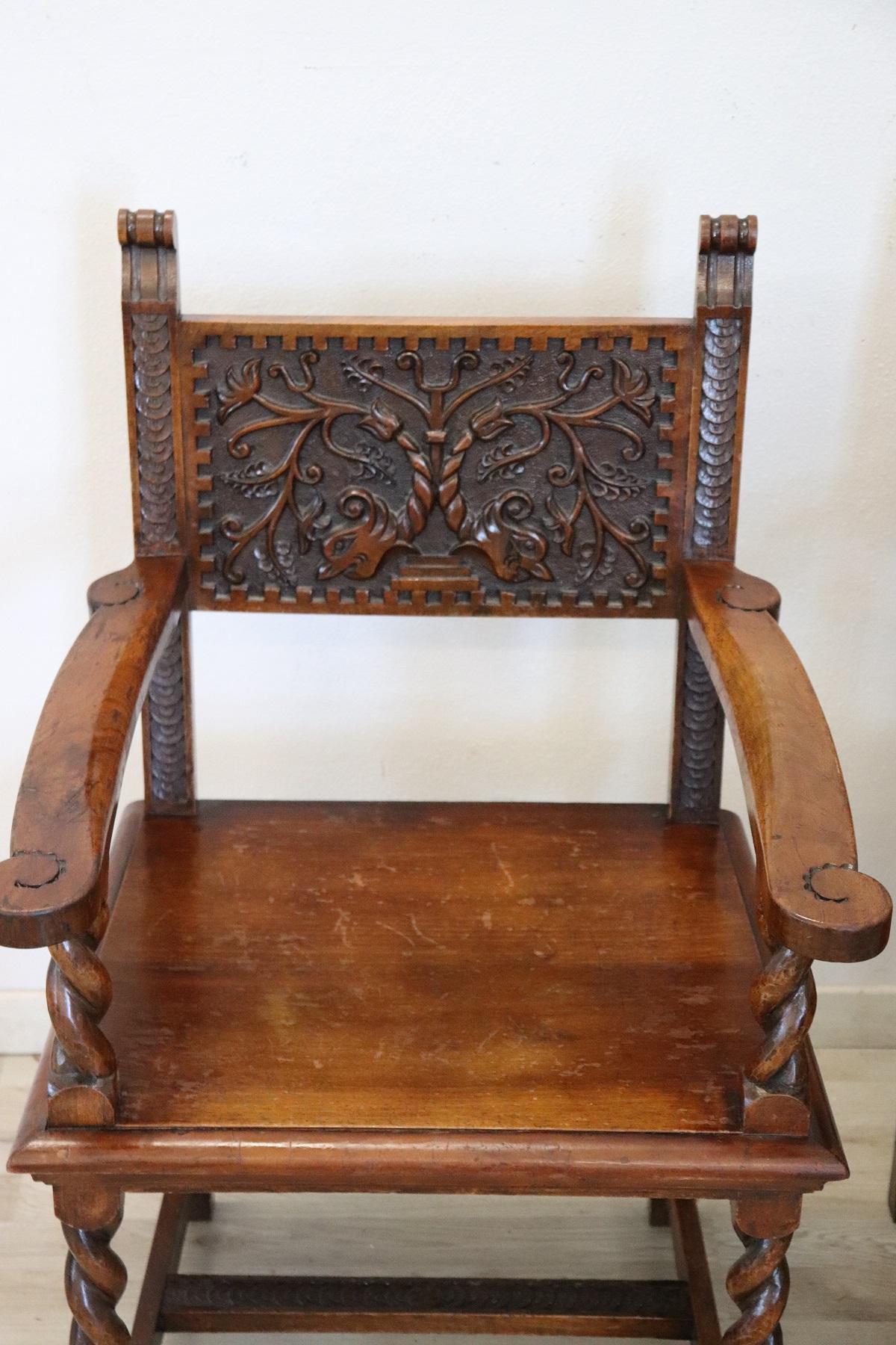 Impressive rare pair of throne chairs in perfect Italian Renaissance style. Made of solid walnut wood. The finely carved wooden backrest with very complex decoration. The armrests and legs are in turned solid walnut. Perfect for use as a head of the