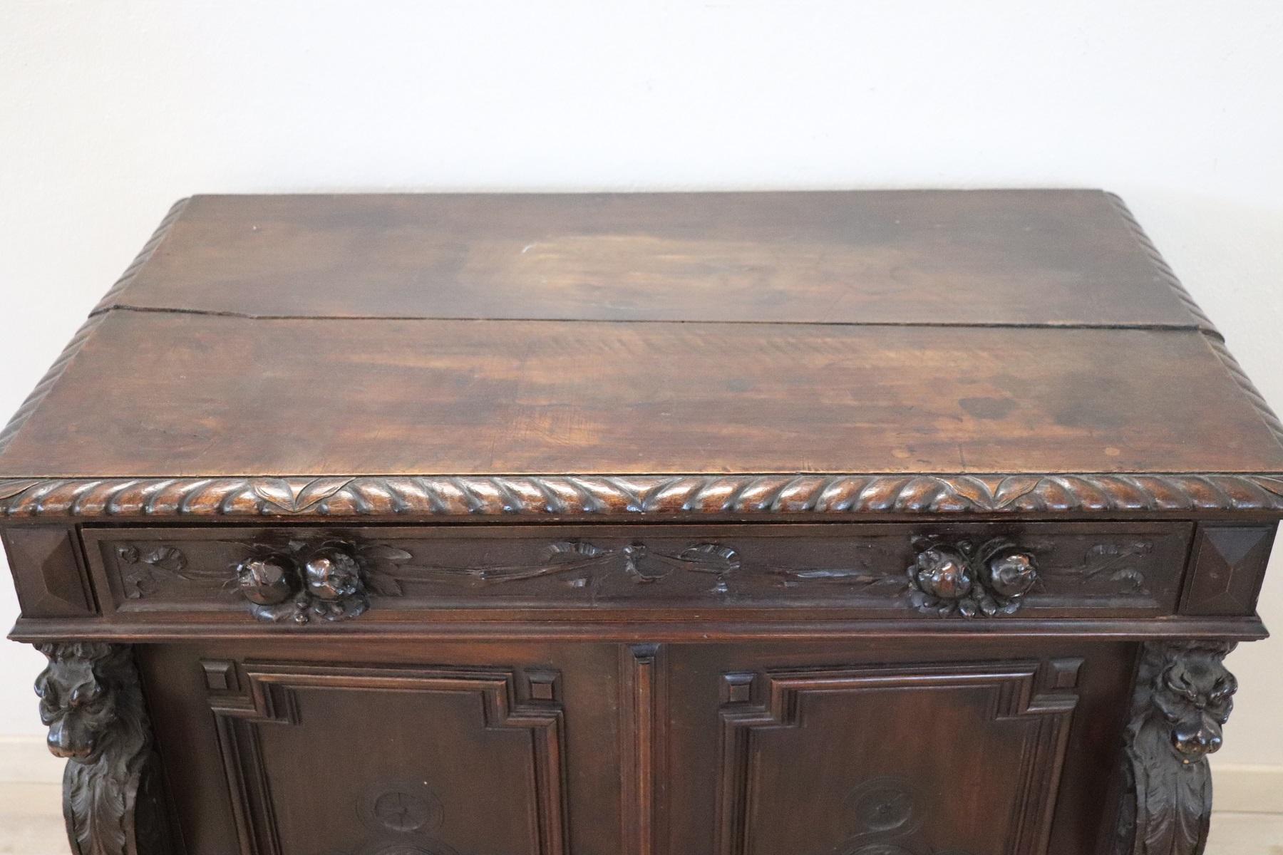 Beautiful antique Renaissance style sideboard featuring carved walnut wood. On the front mythological figures carved on the sides. The two drawers have handles carved in wood. Its small size is an advantage because it can also be inserted in small