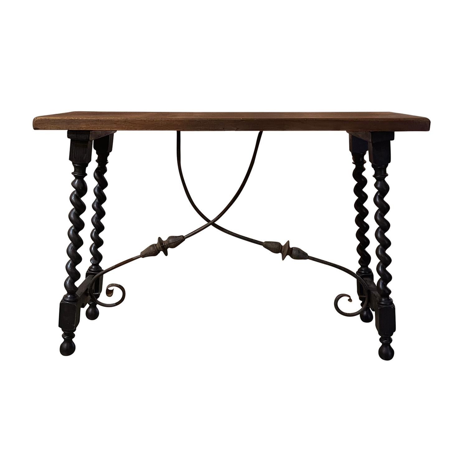An antique 19th century Tuscan Renaissance style table or console topped with a warm and rich colored rectangular Walnut table top, in good condition. The table base has twisted hand turned legs in walnut refinished with dark wax. The wooden base is