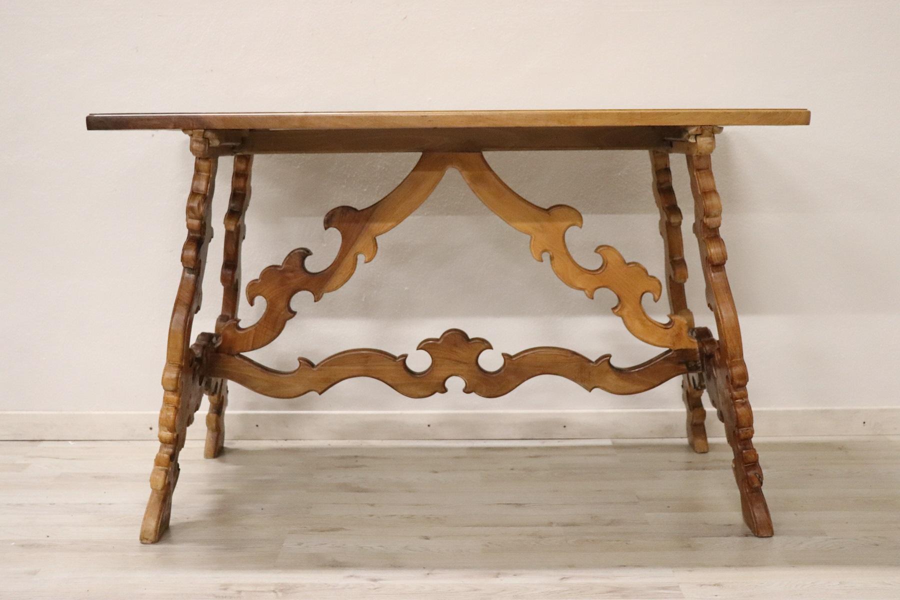 Beautiful antique table in solid walnut of a splendid honey-colored hue. The table has a carving in the lyre-shaped legs. The legs have numerous swirls. This table is in perfect condition ready to be placed in your home and used immediately. It can