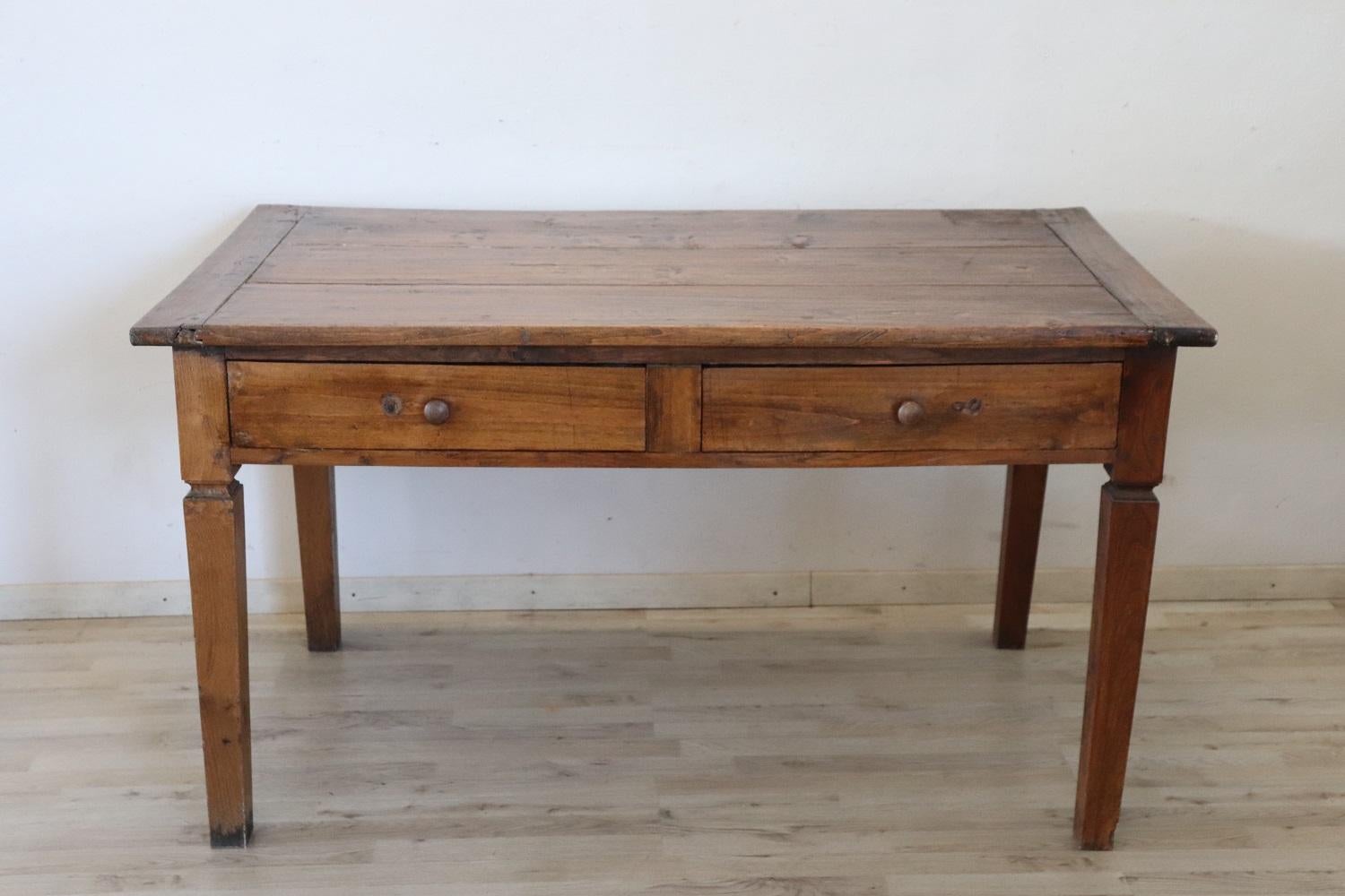 Beautiful very nice Italian solid poplar and oak wood kitchen table, 1850s. The table is very simple and linear, characterized by solid legs. Equipped with a two large drawers. This rustic table is perfect for a country home and can be used in a