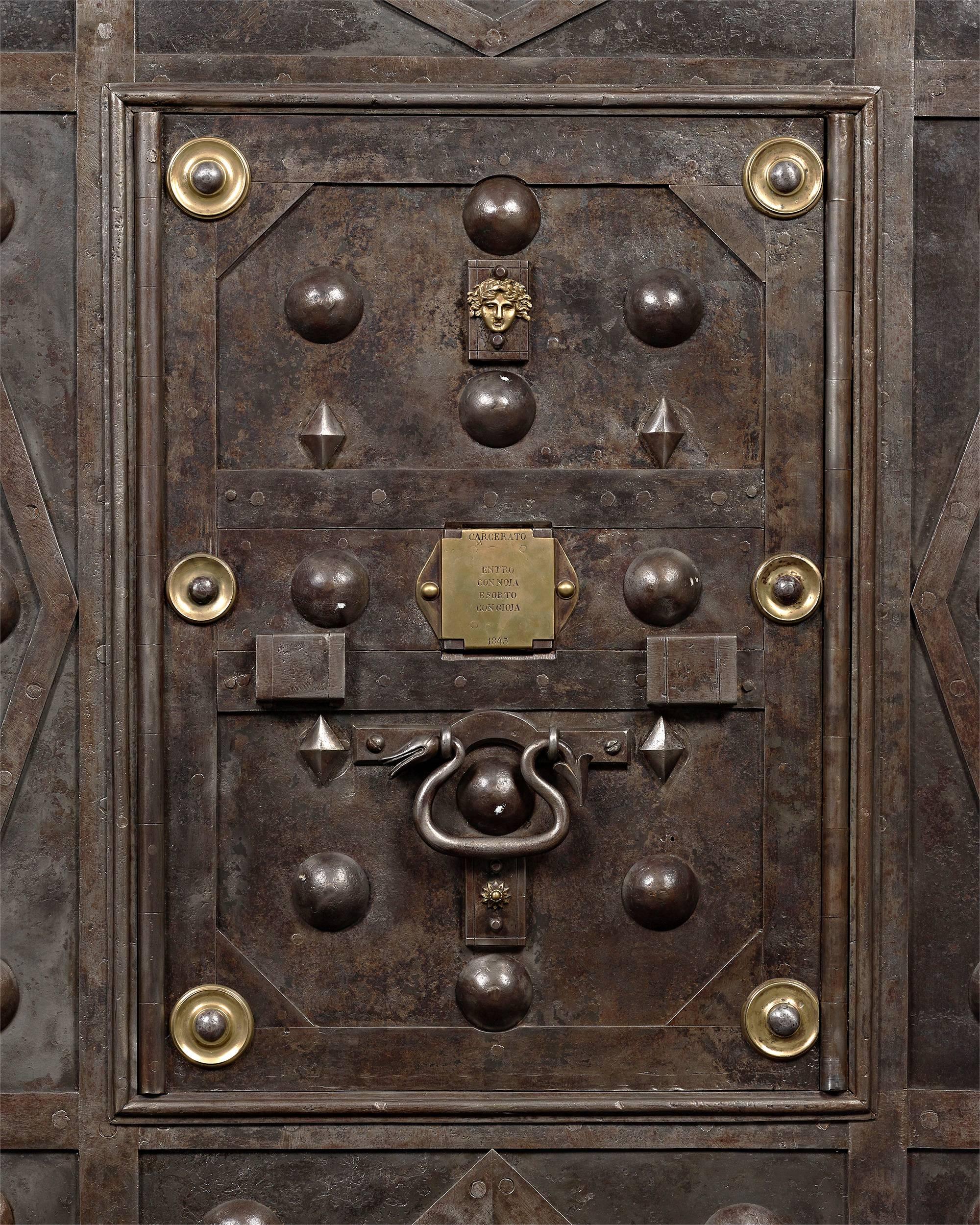 Size, security and exceptional craftsmanship distinguish this fully functioning 19th century Italian floor safe. Weighing hundreds of pounds, the fascinating safe is enveloped with thick iron plates and features one of the most intricate locking