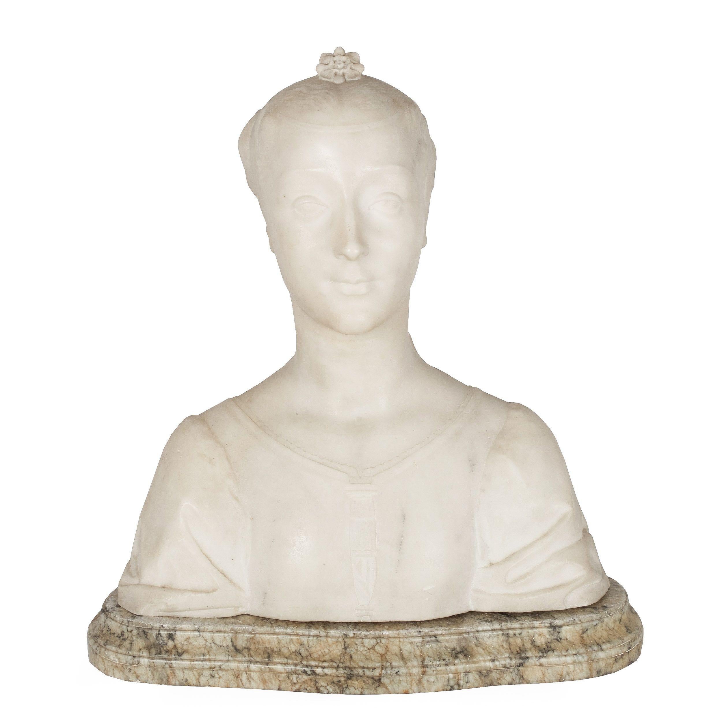 A serene decorative work portrait, this bust is carved out of a solid block of alabaster. Her features are sharp and attractive, her hair pulled back tightly and held in place with a series of straps crested by a pierced floral piece of jewelry. Her