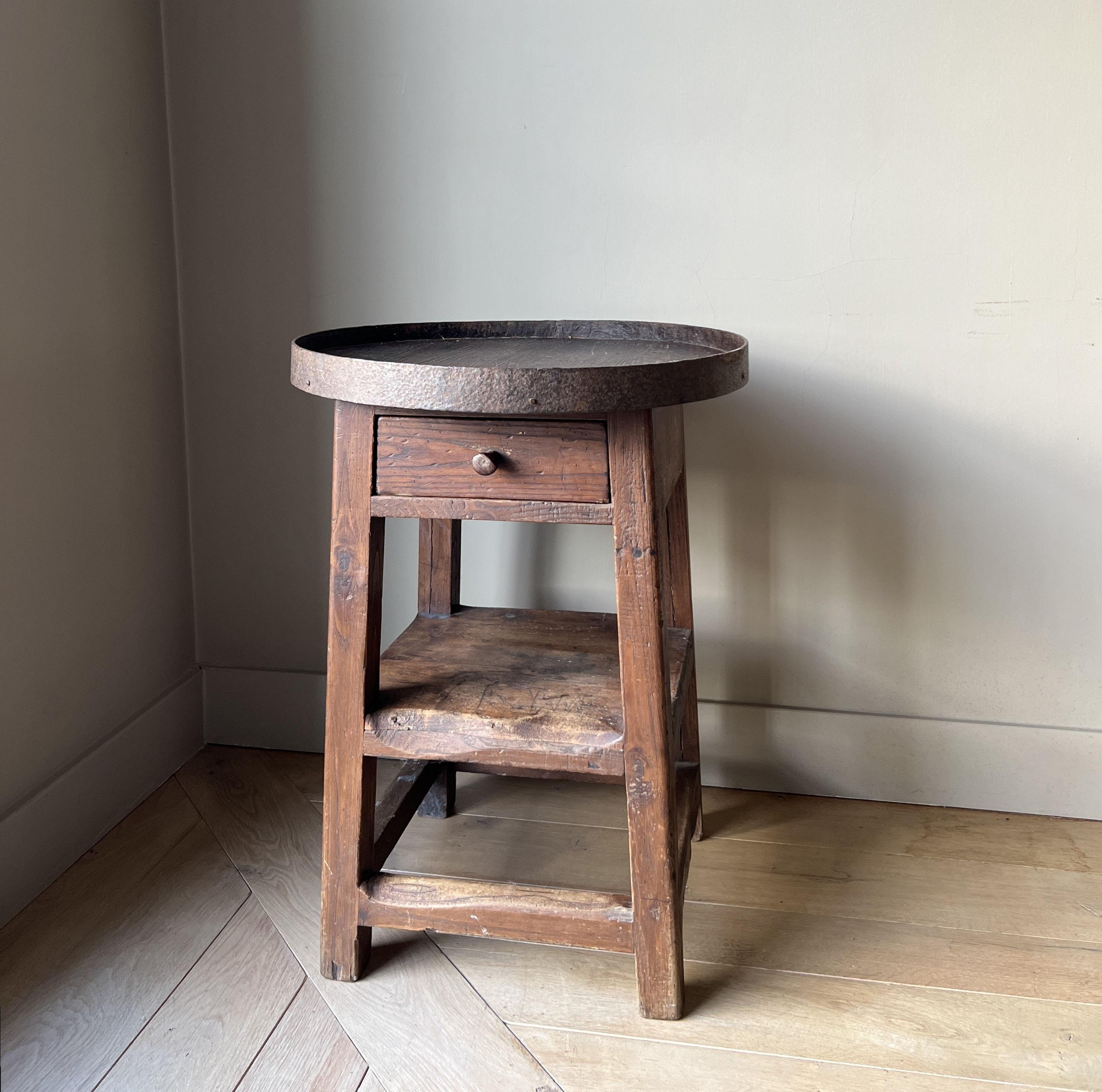 A great little 19th century round table. Originally designed for working (possibly sculptor) the top has small divisons to organise tools. Overall wonderful color and patina and a good proportions. Caould be used as a sidetable or a pedestal. Very