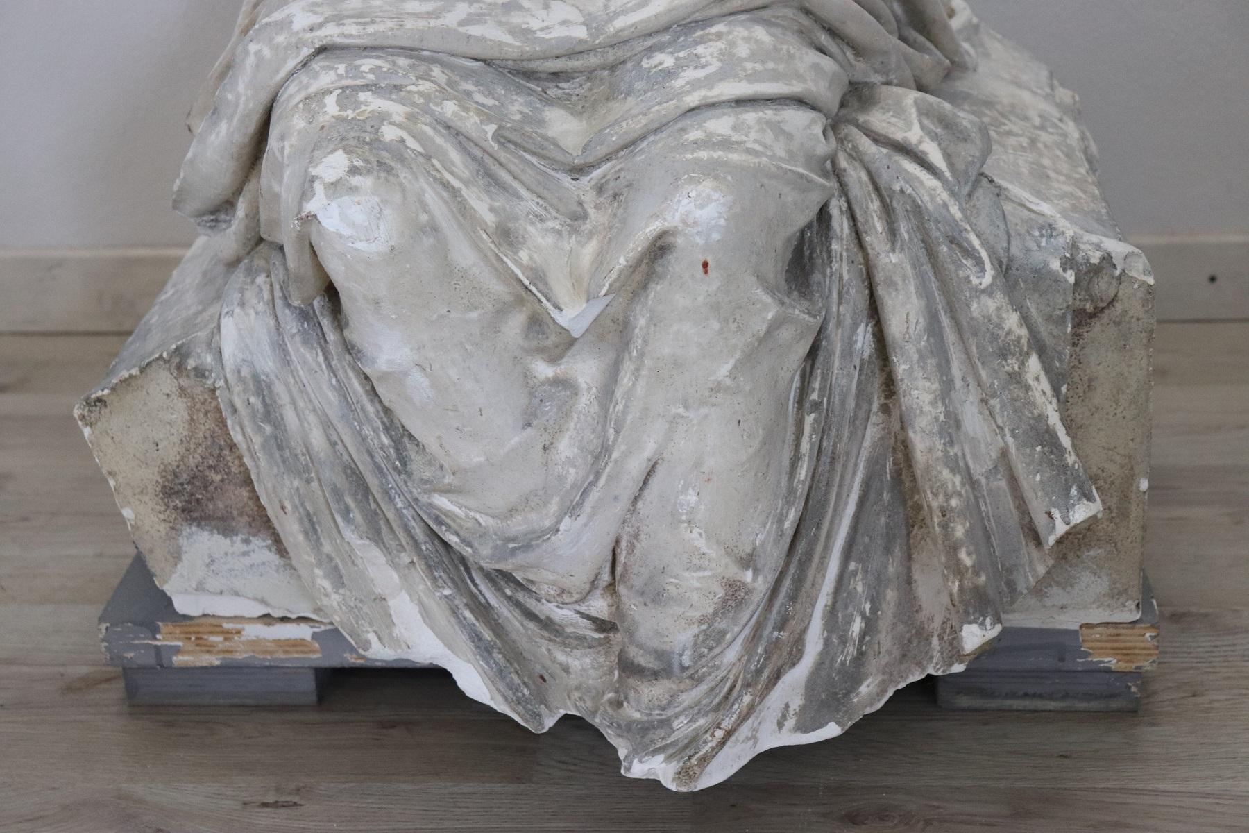 Refined Italian sculpture in plaster. The girl with simple clothes probably a young peasant is sitting in a moment of tranquility. The face is very sweet and perfect in the lines it seems absorbed in his thoughts. He is holding a bunch of wheat